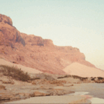 Remote Socotra Island coastline with cliffs and sandy beach at sunrise