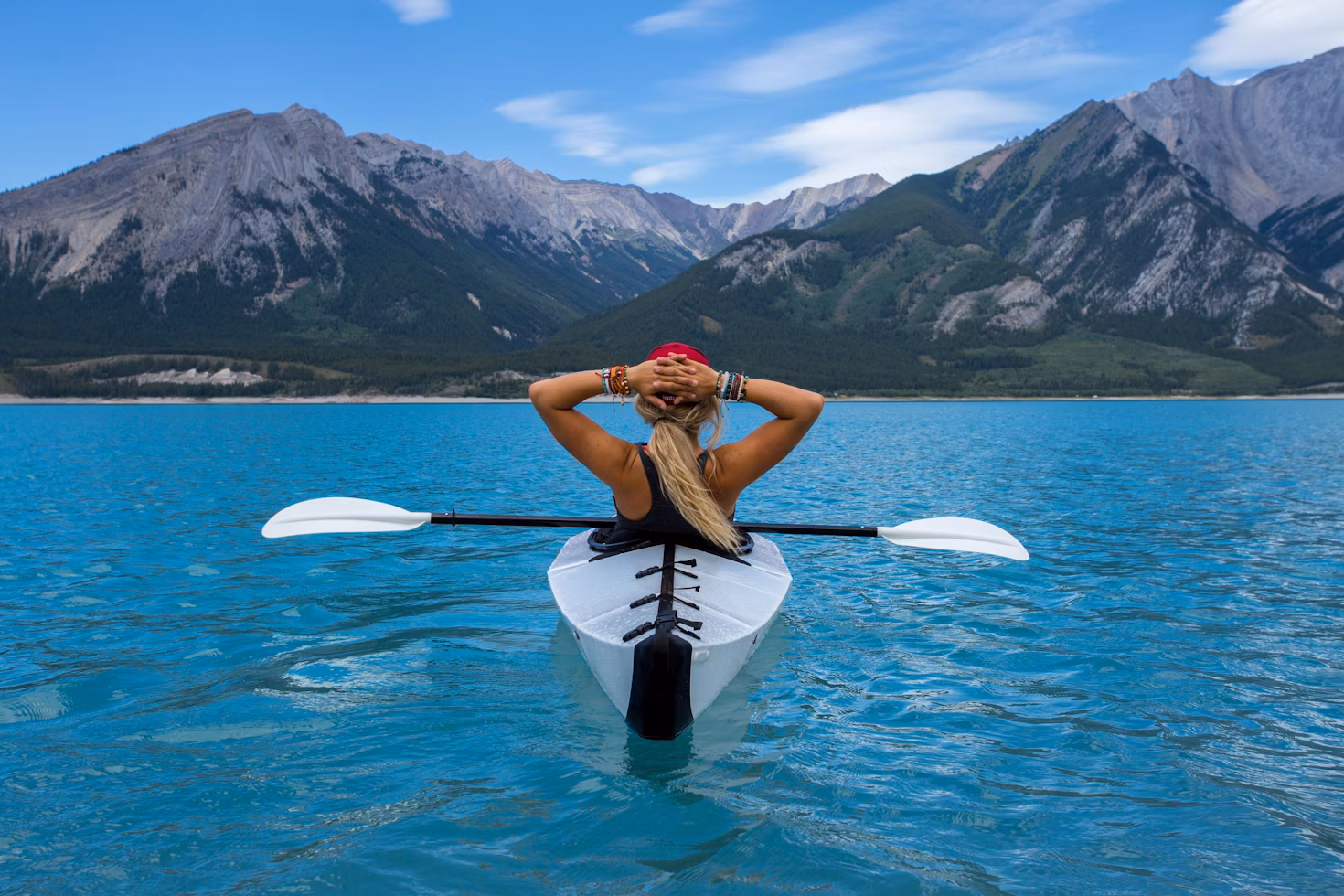 woman riding kayak at the middle of the sea
