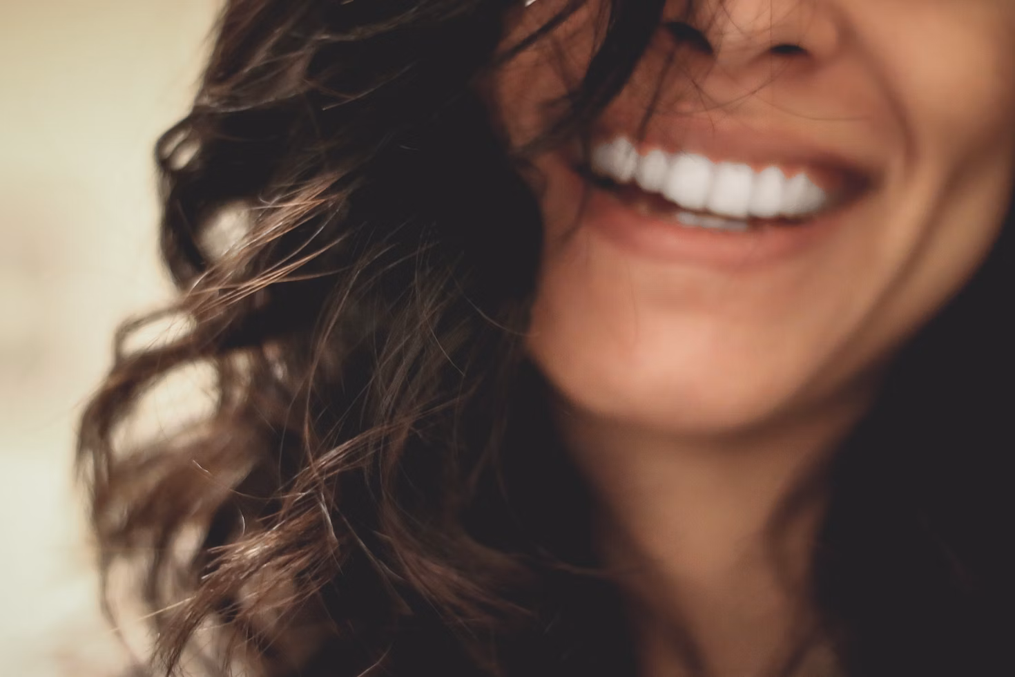 long black haired woman smiling close-up photography
