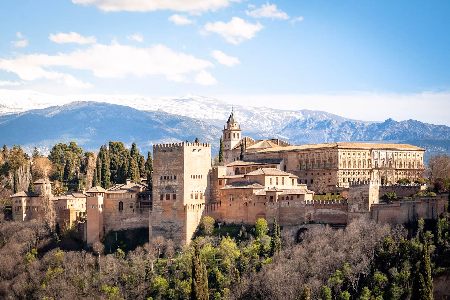 Alhambra palace in spring, Granada, Spain. In early April the mountains are still covered in snow.

