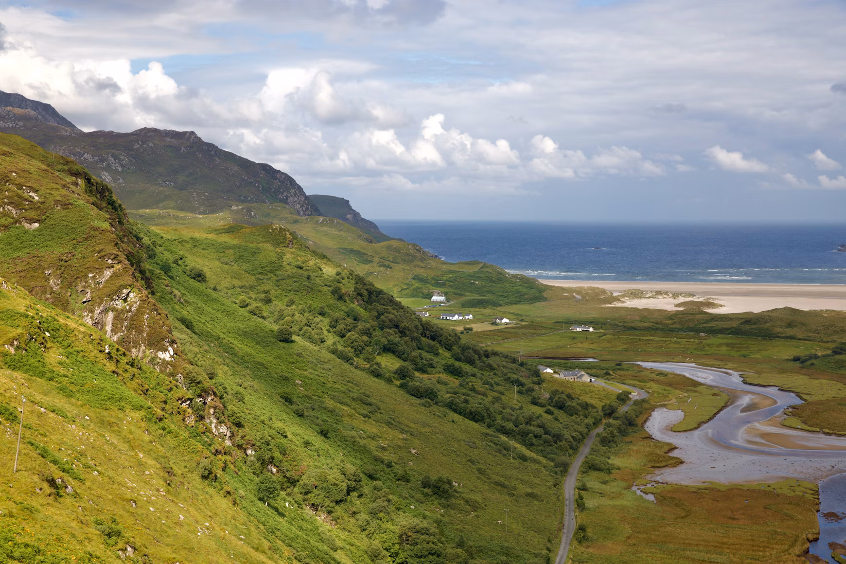 Winding mountain road leading to Maghera Beach in Donegal, symbolizing the journey to Ireland’s hidden beaches.