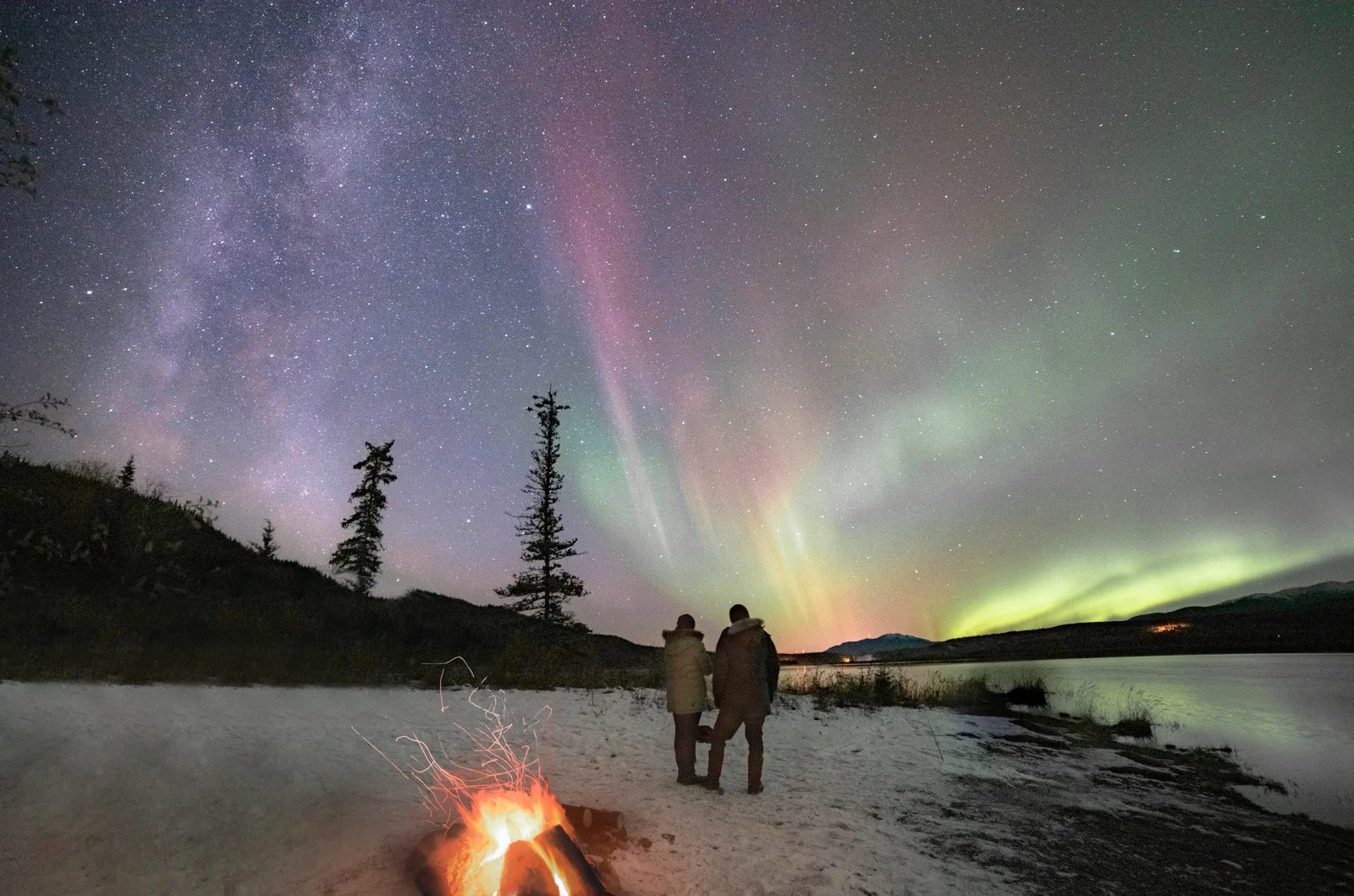 Northern Lights over Canada’s frozen lake — a top retirement bucket list travel idea for middle-class retirees.