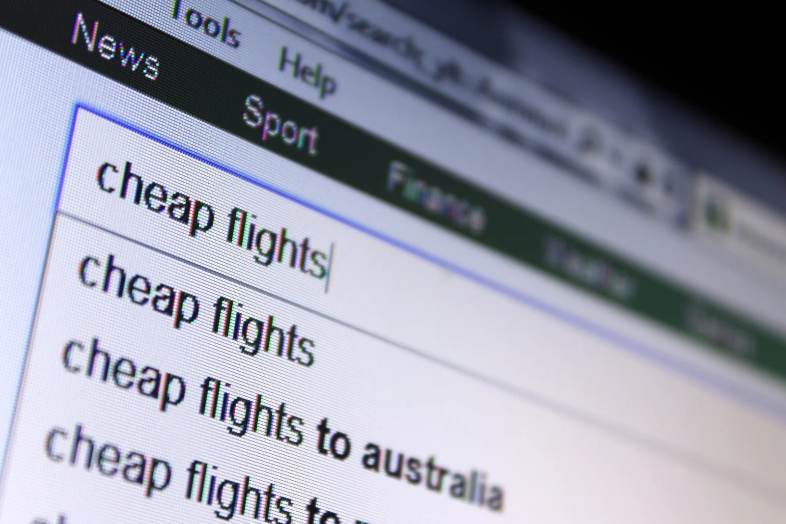 Close-up of a computer screen with the search term “cheap flights,” emphasizing online tools for affordable travel planning.