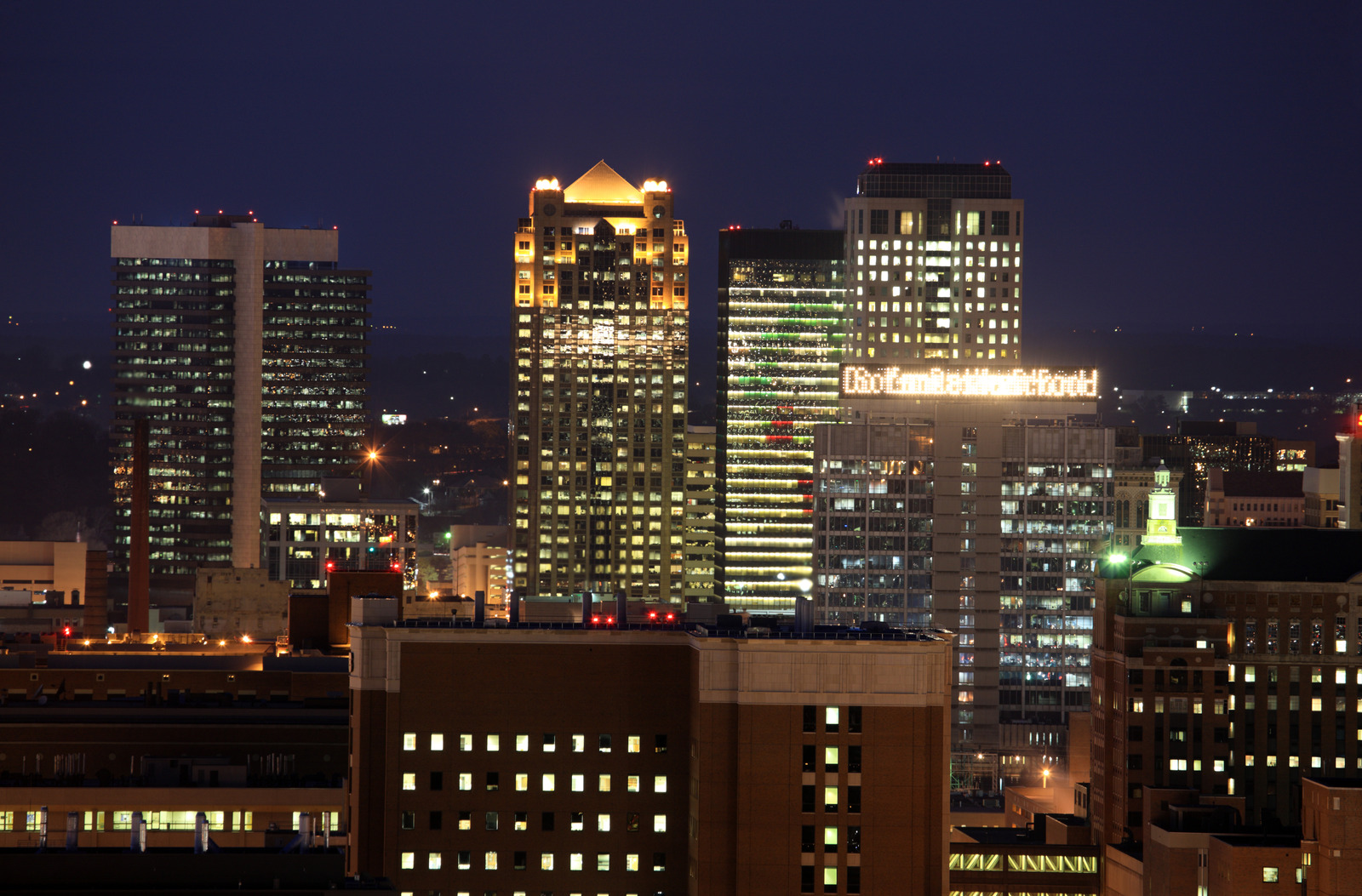 Birmingham Alabama skyline at night representing dangerous cities in America and fear of walking alone.