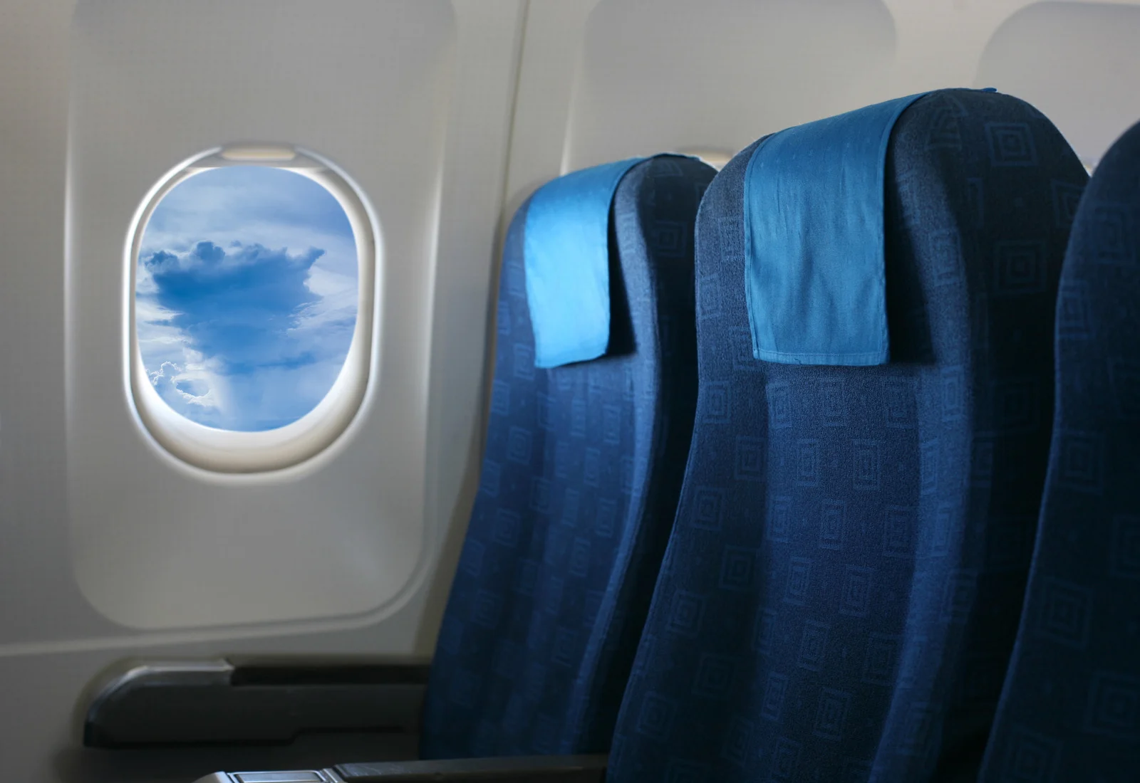 Empty airplane row showing how paying for an extra seat helps travelers feel less crowded on a plane.