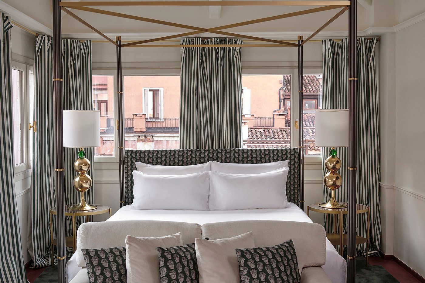 Elegant boutique hotel room at Violino d’Oro in San Marco, Venice, with striped curtains and Murano details.