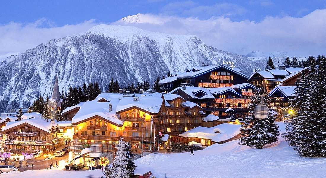 Snow-covered Alpine village of Courchevel, home to Le Chalet de Pierres, a favorite among royal family restaurants for fireside dining.