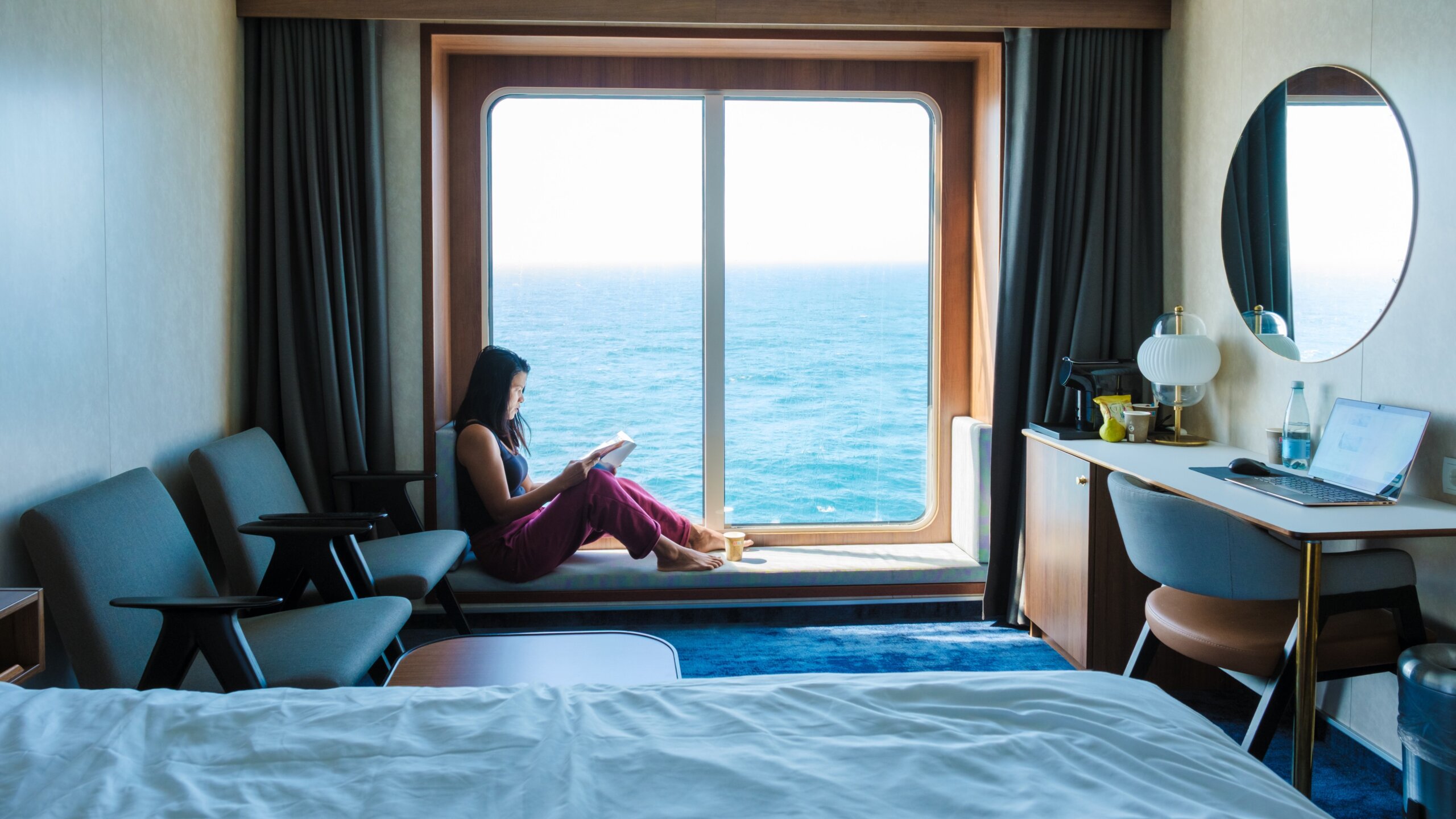 Serenity at sea A traveler enjoys a peaceful reading moment in a cozy cabin
