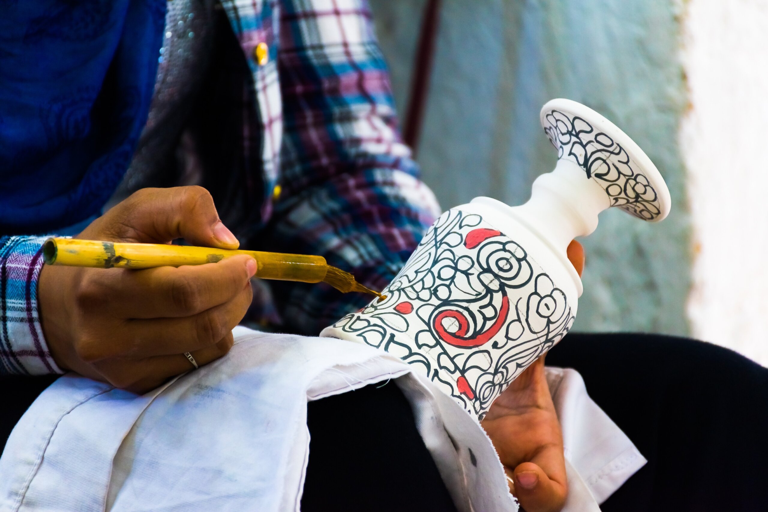 A moroccan pottery maker creates ceramics in a workshop in old medina of Fez, Morocco in Africa
