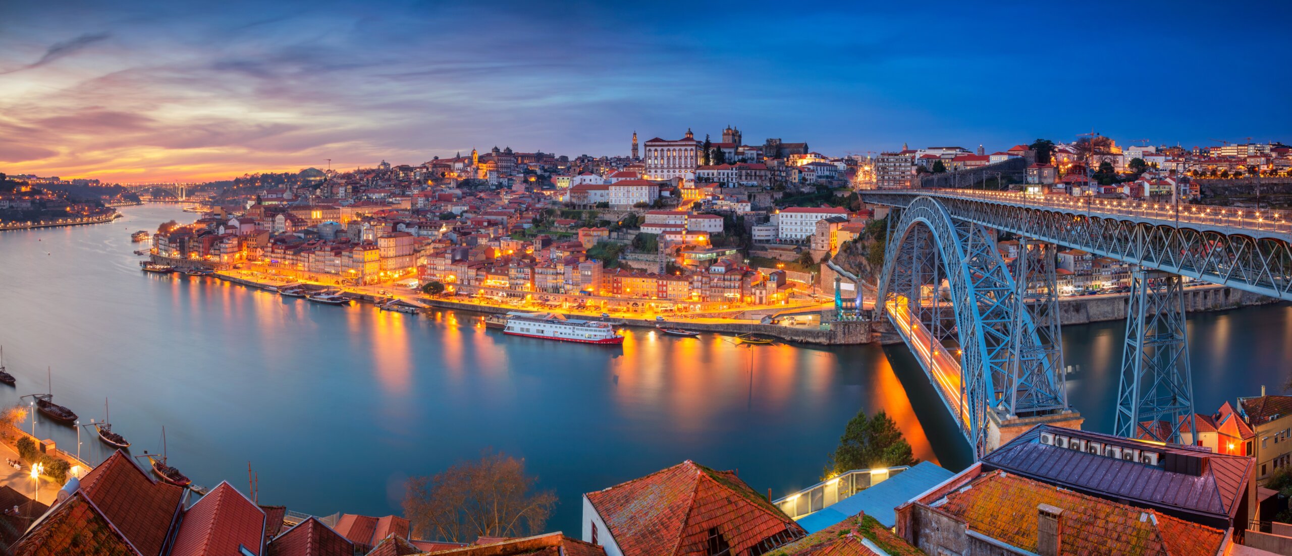 Porto, Portugal. Panoramic cityscape image of Porto, Portugal with the famous Luis I Bridge and the Douro River during dramatic sunset.
