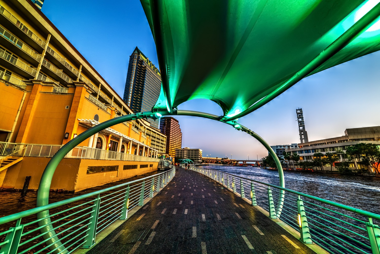 Green shelter by Tampa Riverwalk at sunset
