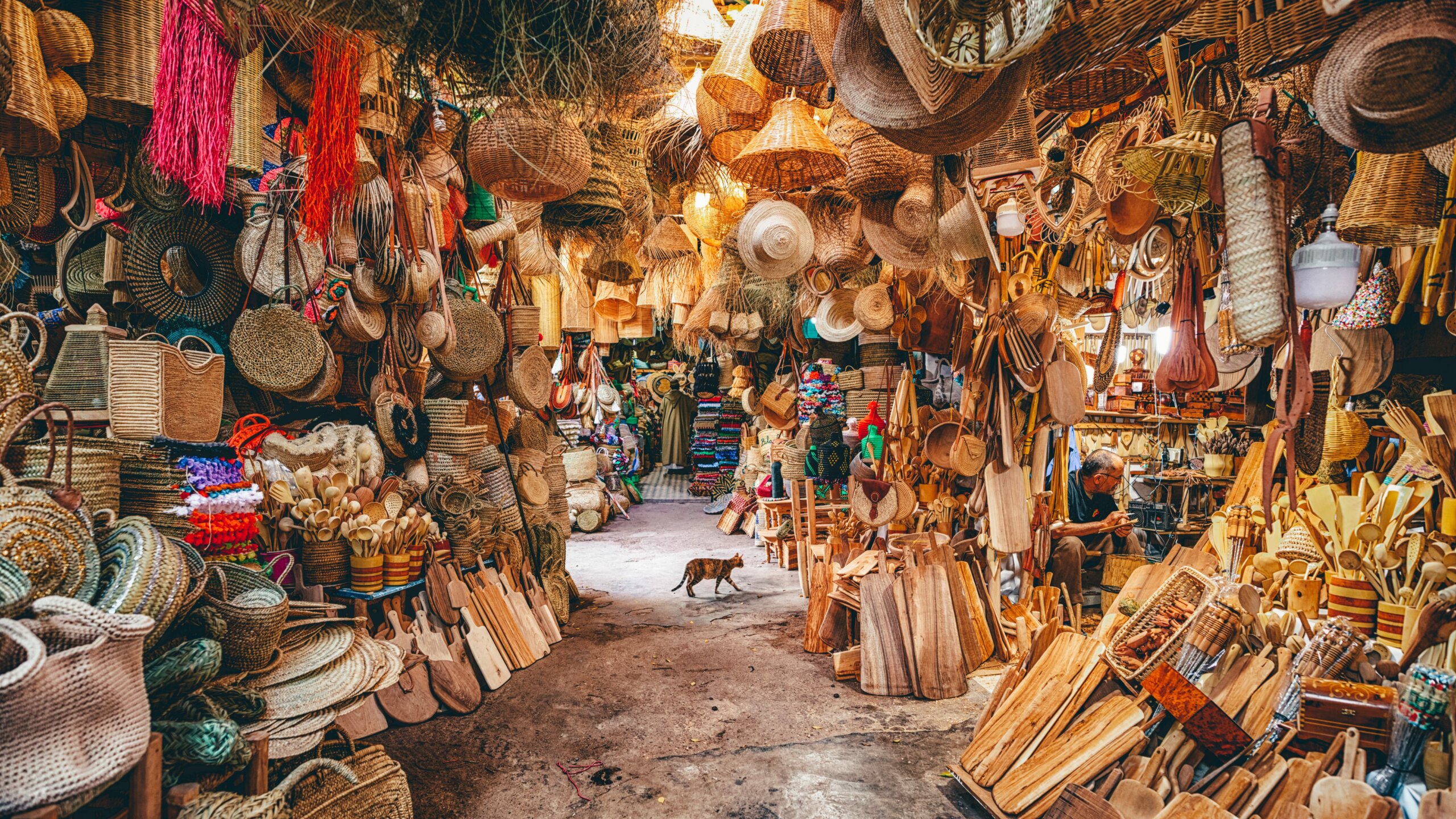 Moroccan market with handmade baskets, woven goods, and artisan crafts on display.
