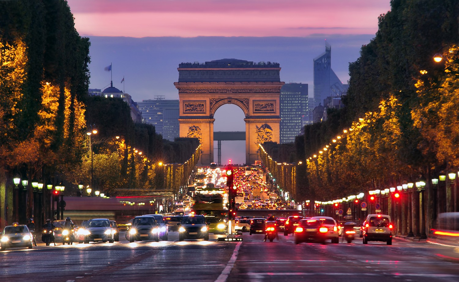 Champs Elysees and Arc de Triomphe in Paris France. night scene with car traffic
