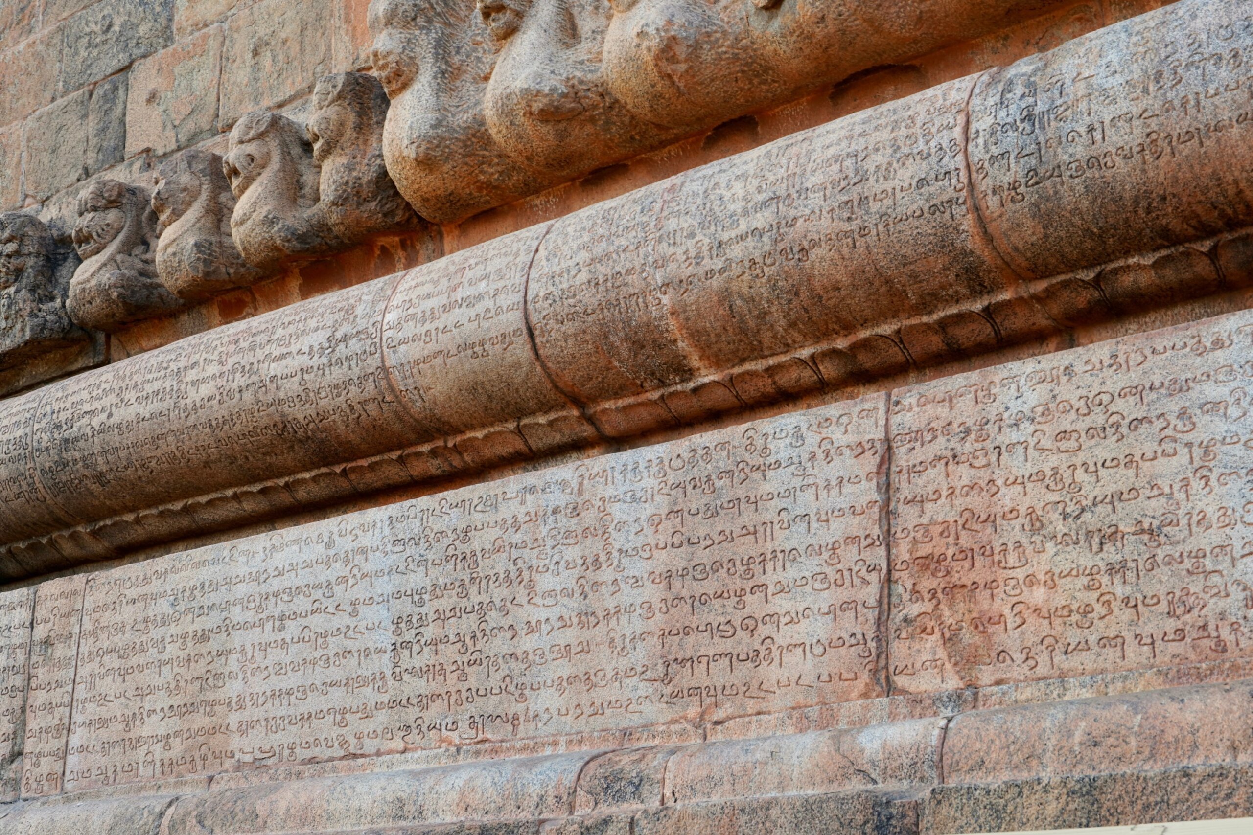 Inscriptions of Tamil language carved on the stone walls at Brihadeeswarar temple in Thanjavur, Tamilnadu, India. Ancient tamil inscriptions carved in the exterior temple walls in Thanjavur.