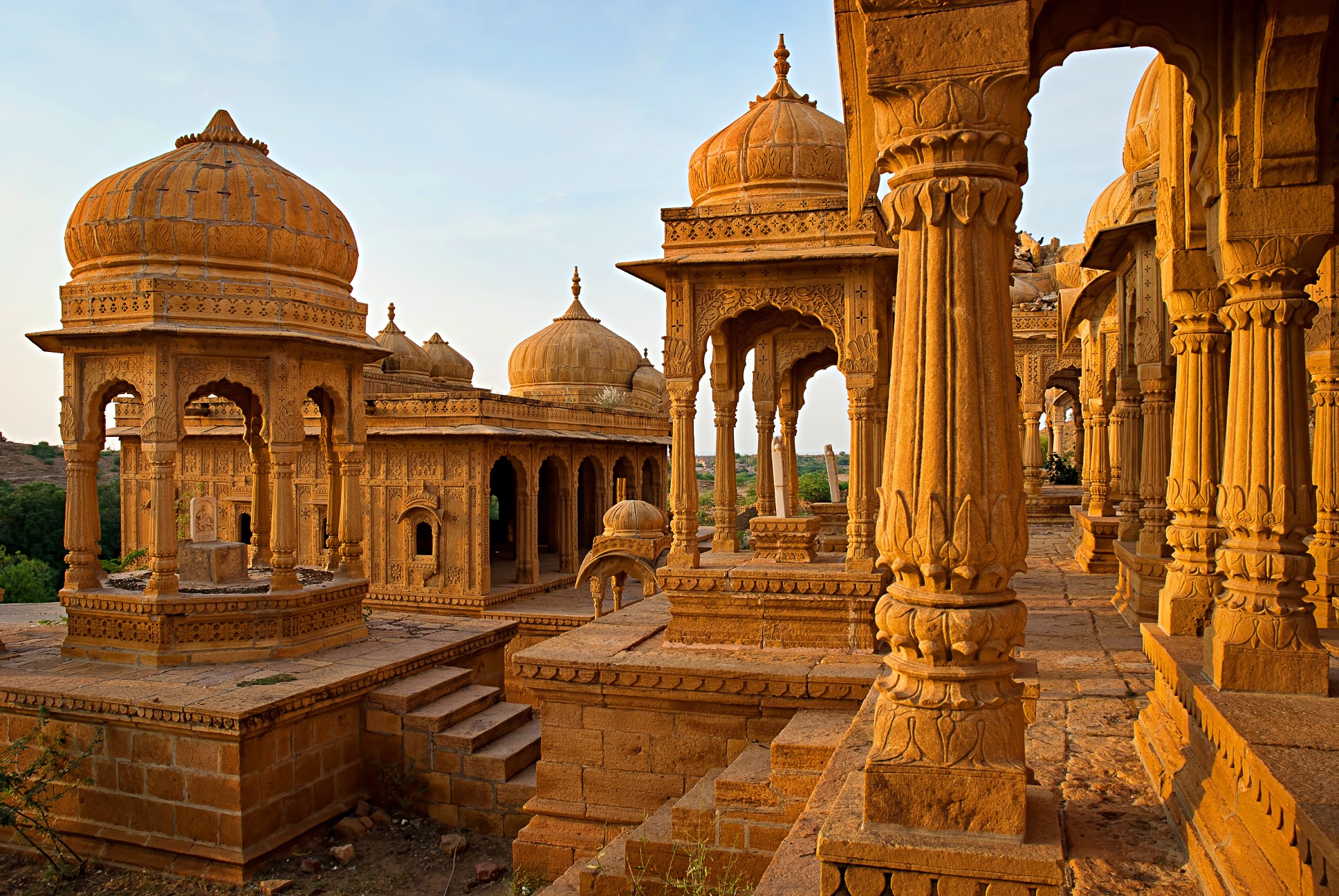 Golden sandstone palaces in Rajasthan, India at sunset showcasing intricate architecture and royal heritage.