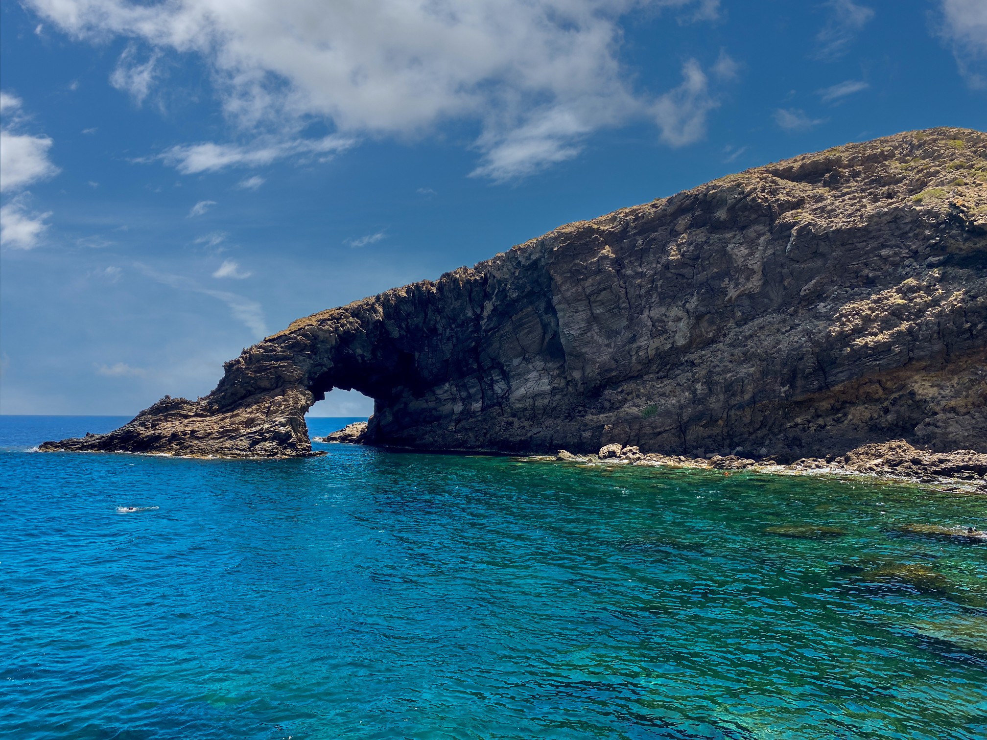 Elephant Arch huge lava rock cliff plunging into the water forming an arch is the symbol of the island of Pantelleria, Sicily, Italy
