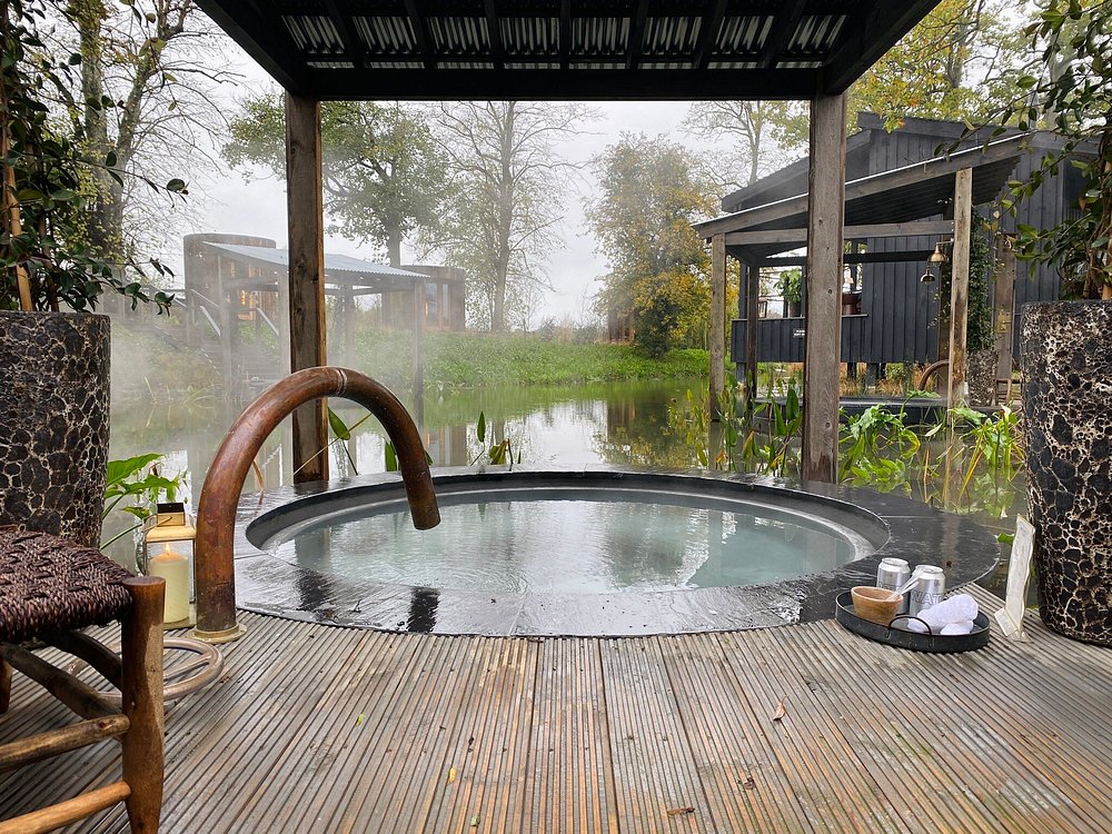 Countryside hot tub view at Soho Farmhouse, a luxurious rural retreat and one of the royal family’s favorite restaurants for private gatherings.