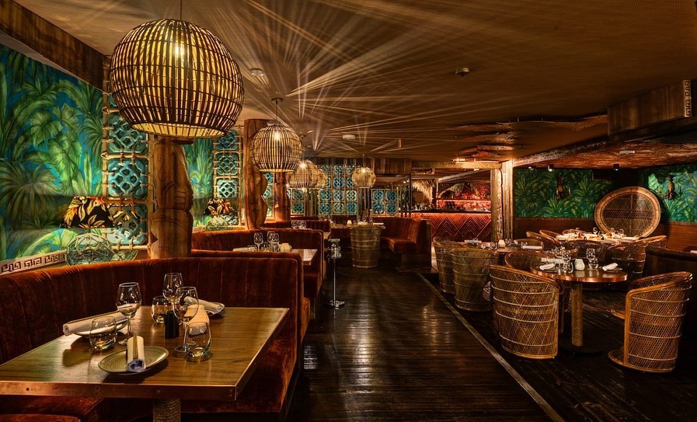 Tropical-themed interior of Mahiki nightclub in London, a vibrant favorite among royal family restaurants and pubs known for its royal connections.
