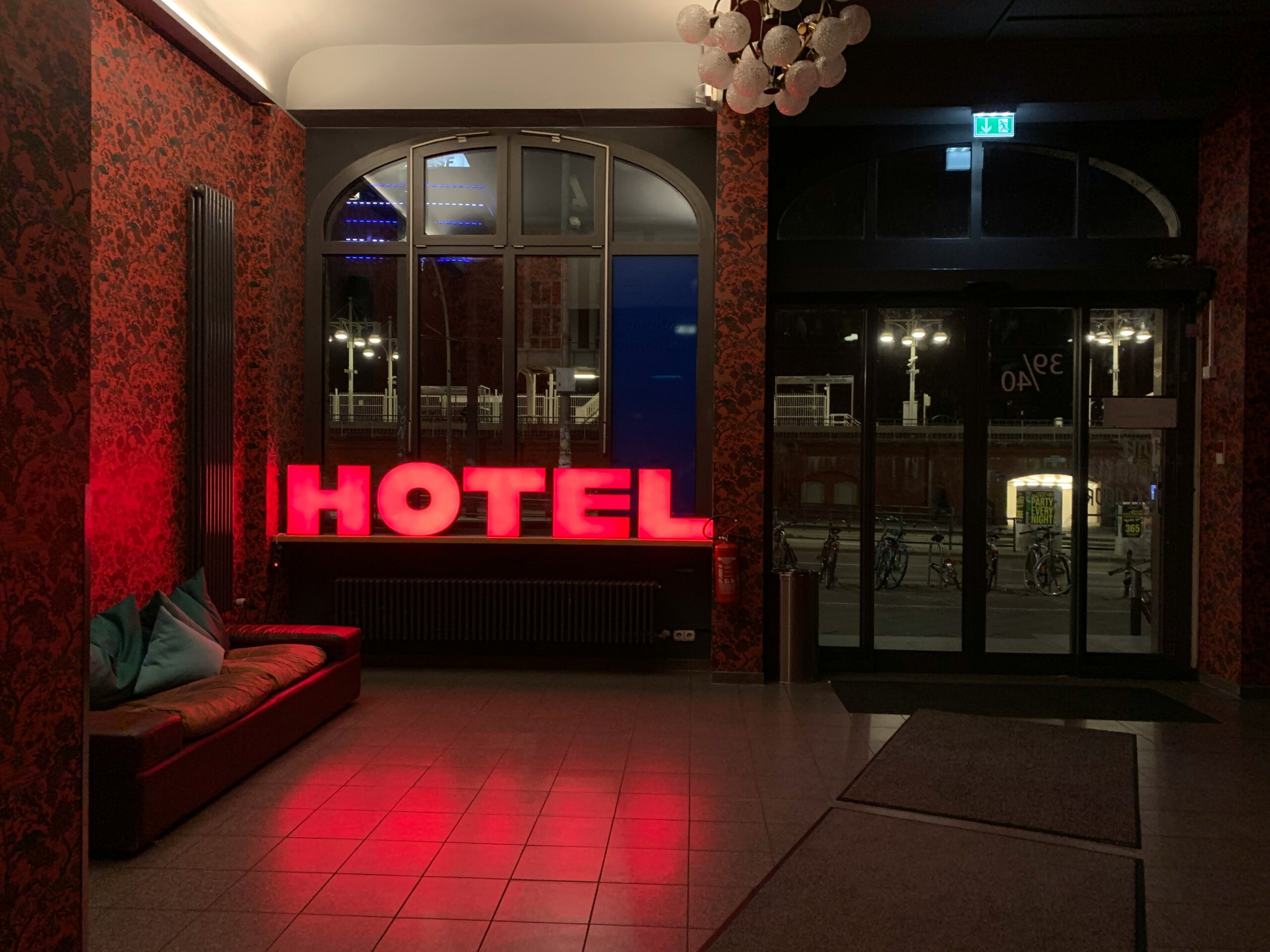 Hotel lobby with red neon sign highlighting red flags to watch for during check-in
