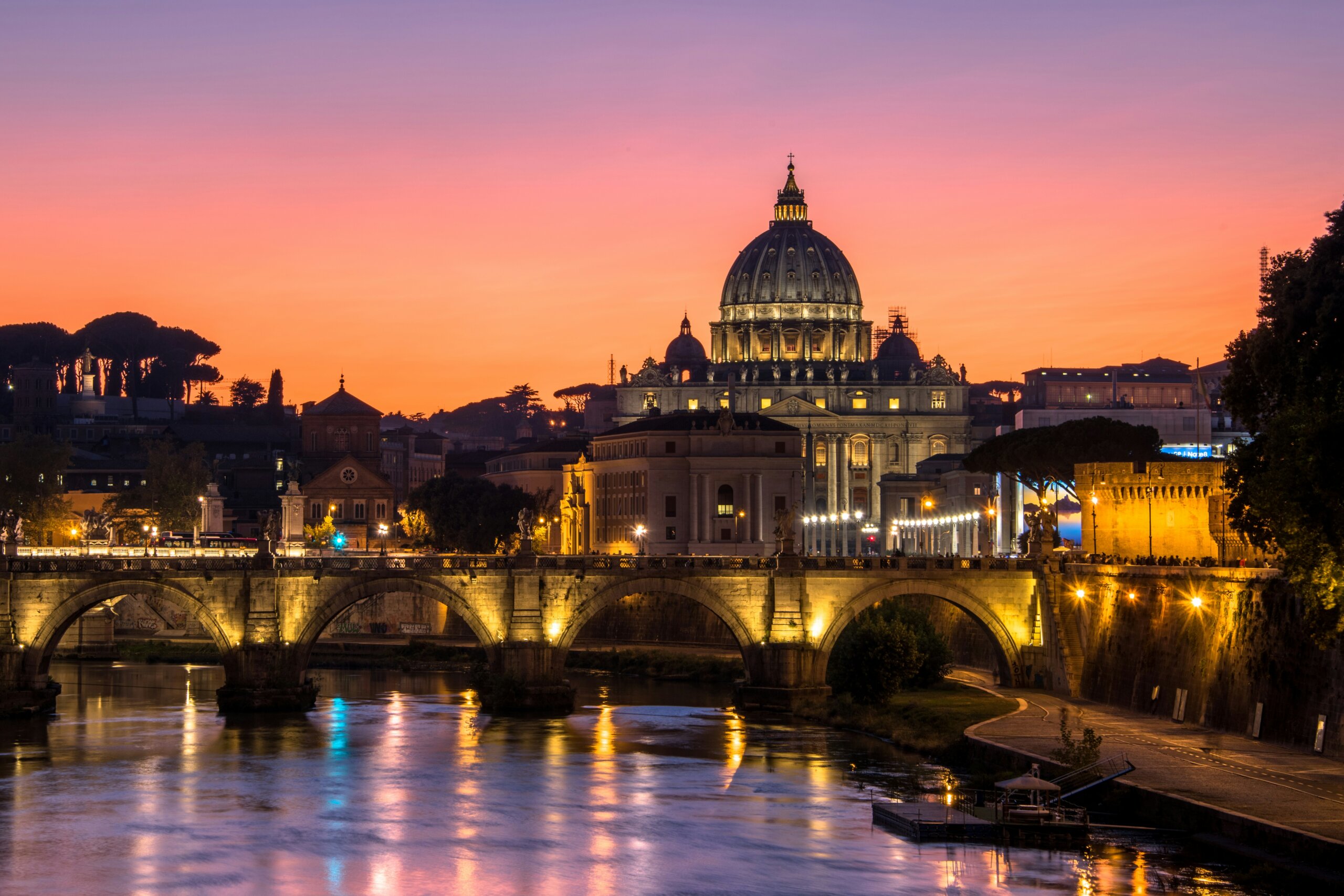 St. Peter’s Basilica and Ponte Sant’Angelo at sunset representing luxury travel in Rome