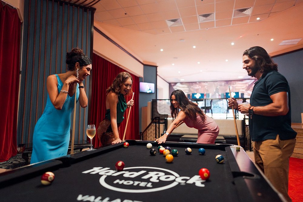 Group of friends playing pool at the Hard Rock Hotel Vallarta