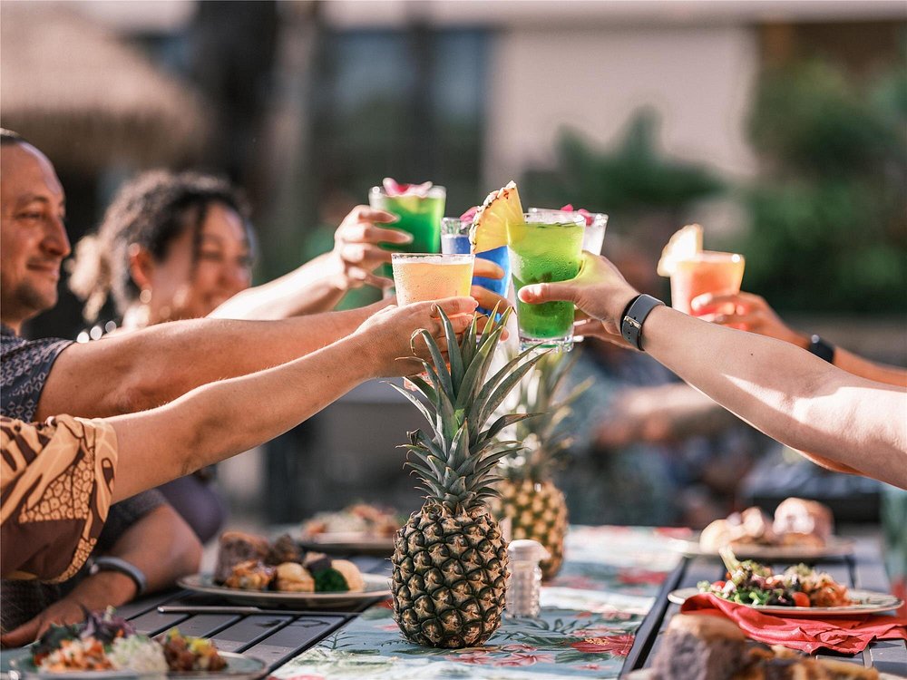 Group of friends raising their glasses at Hyatt Regency Maui Resort and Spa