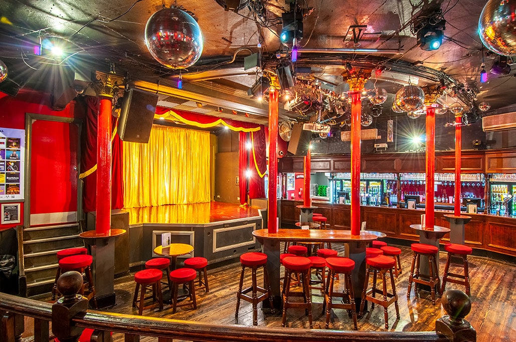 Bright red and gold interior of the Royal Vauxhall Tavern in London, one of the most storied royal family pubs known for Princess Diana’s legendary night out.