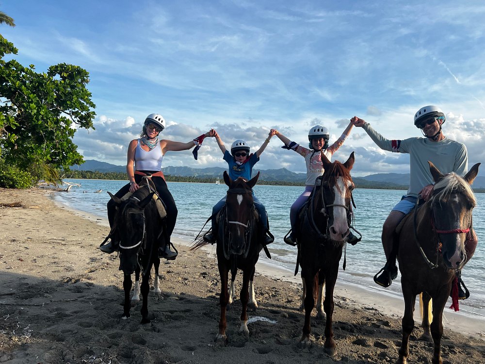 Family on a horseback riding beach excursion at Playa Esmeralda Resort