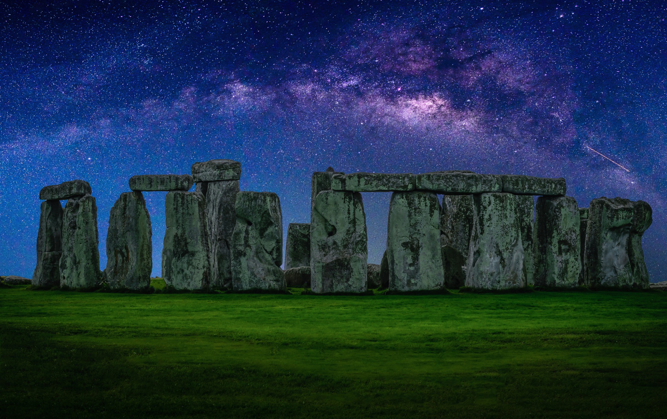 Landscape image of Milky way galaxy at night sky with stars over Stonehenge an ancient prehistoric stone monument, Wiltshire, UK.
