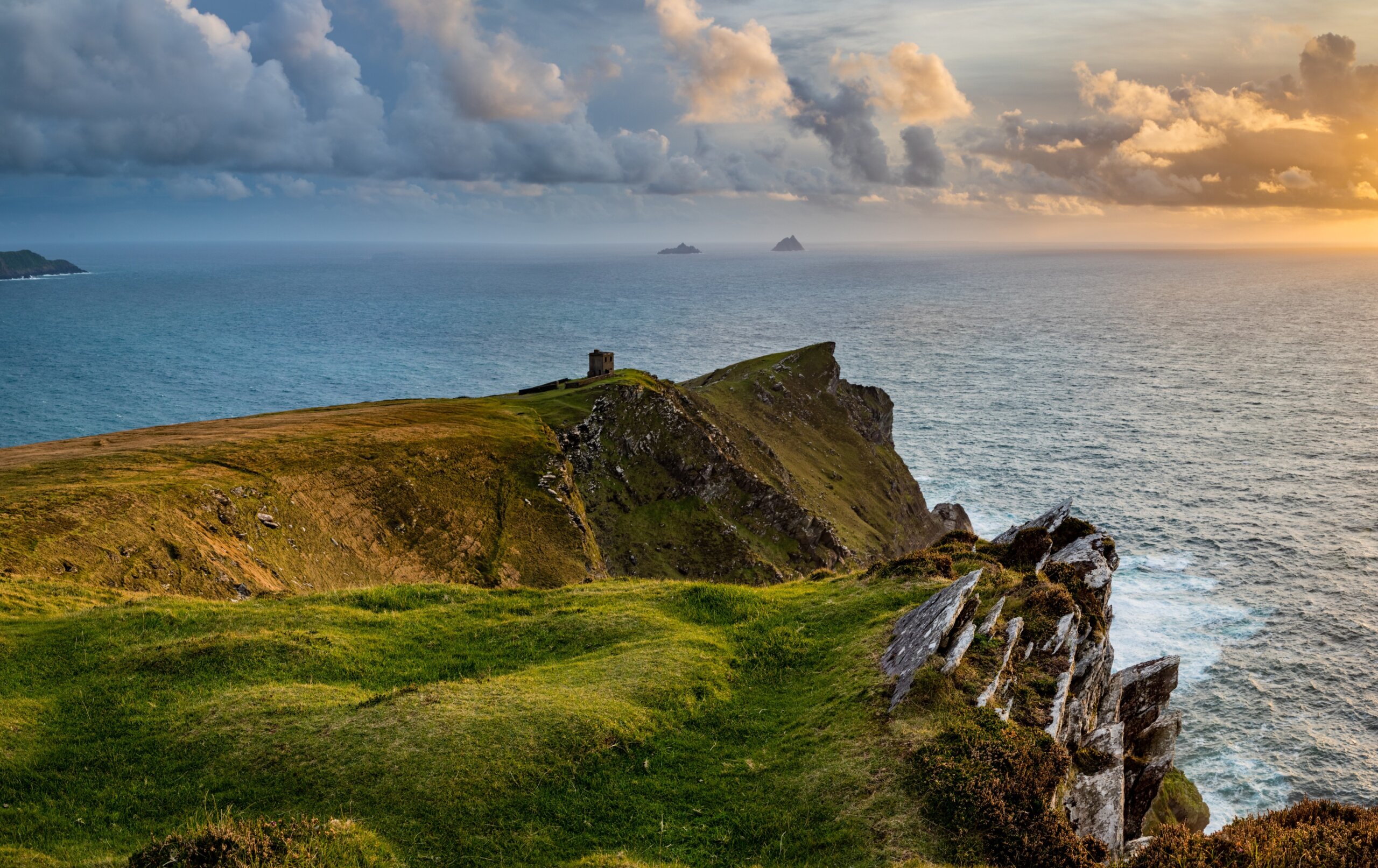 a viewpoint from bray head on valentia island in the ring of kerry in the south west coast of ireland during an autumn sunset showing the skellig islands and watchtower