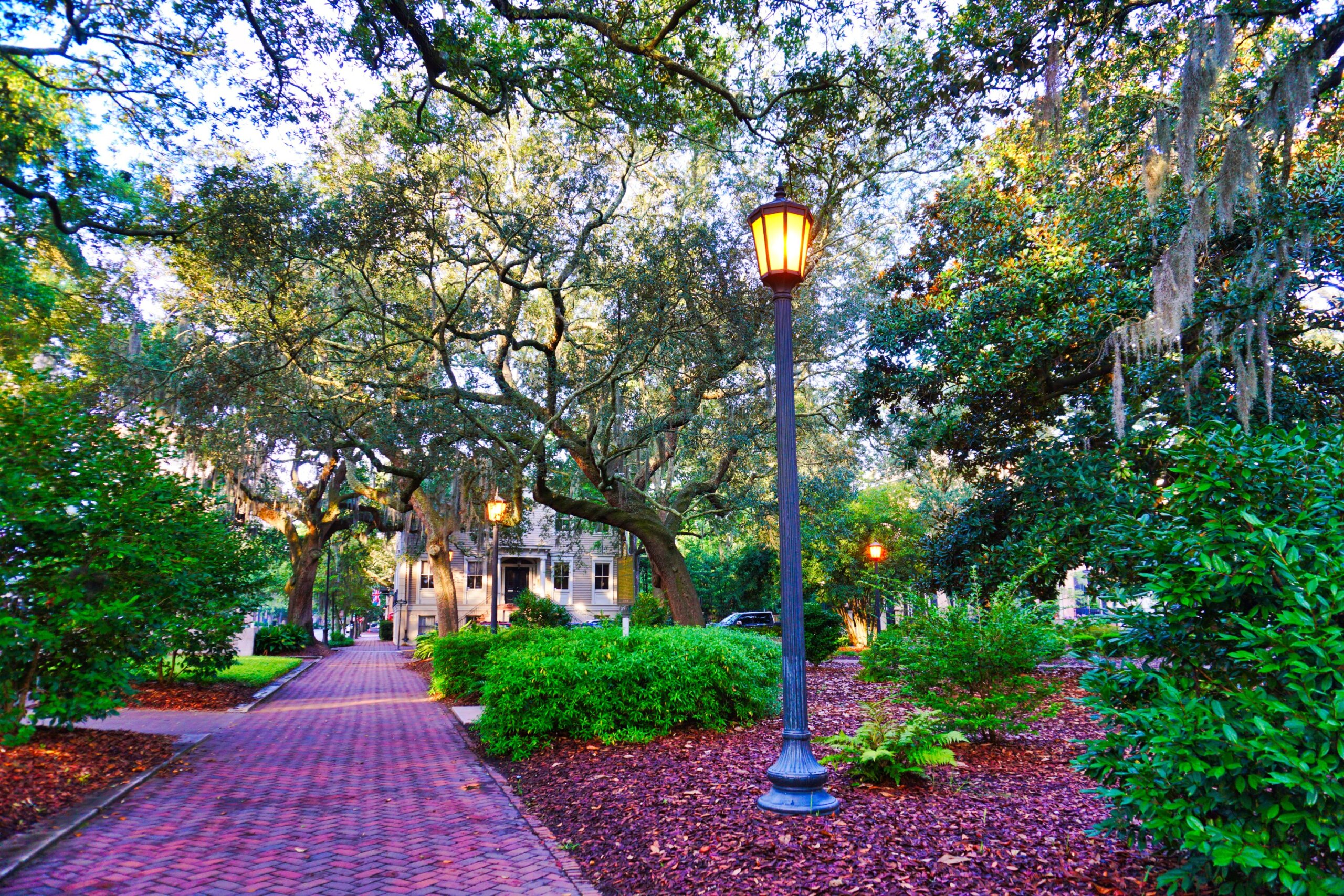 Historic southern town square with brick walkway and oak trees