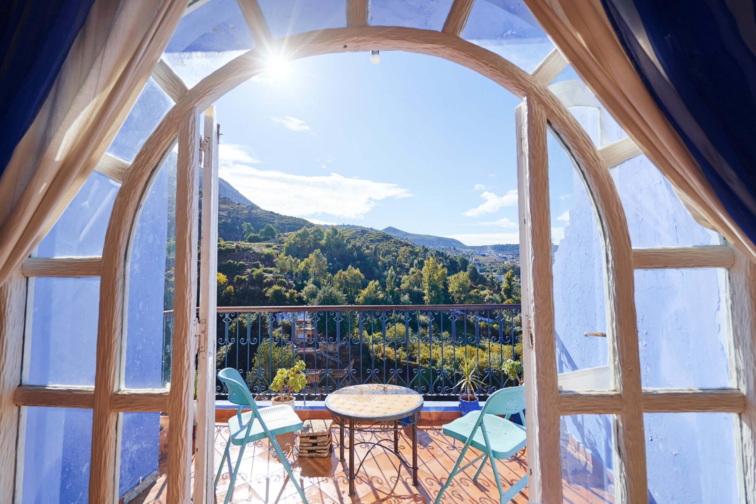 Table and chairs on the balcony terrace with nice view over the Chefchaouen, Morocco.
