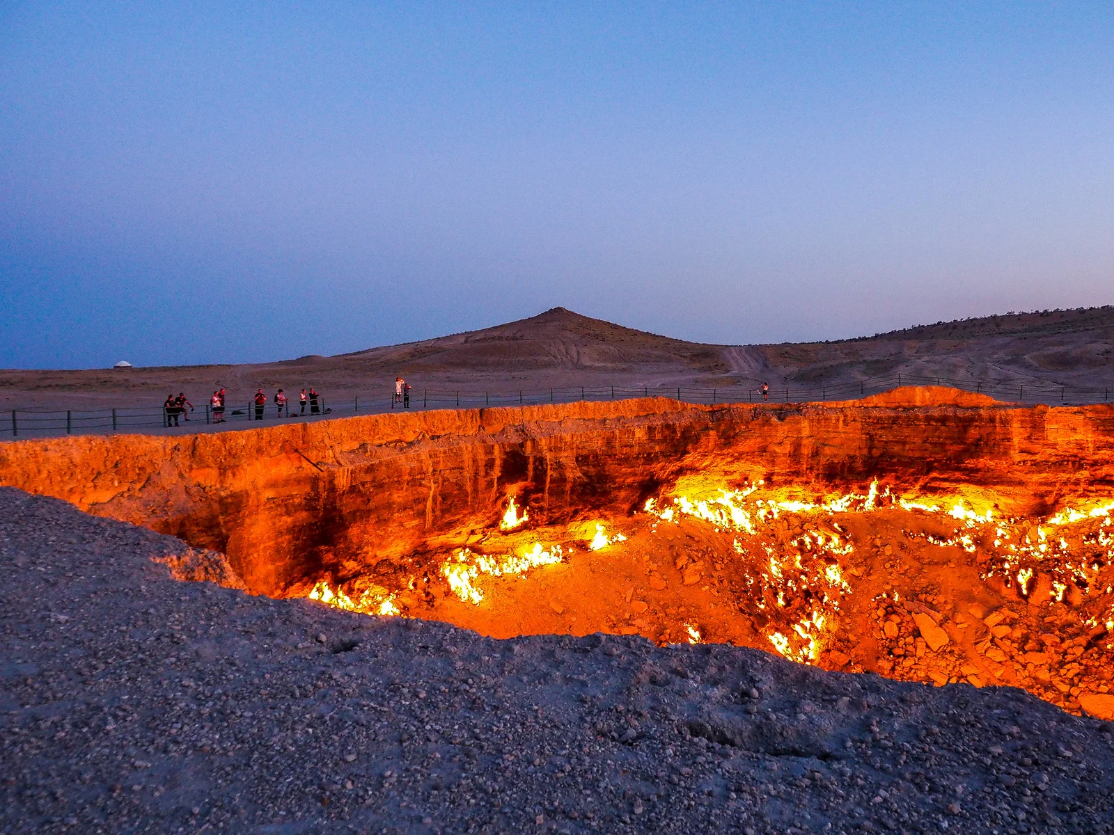 Darvaza Gas Crater flaming pit in Turkmenistan at sunset, one of the most hazardous tourist sites in the world.