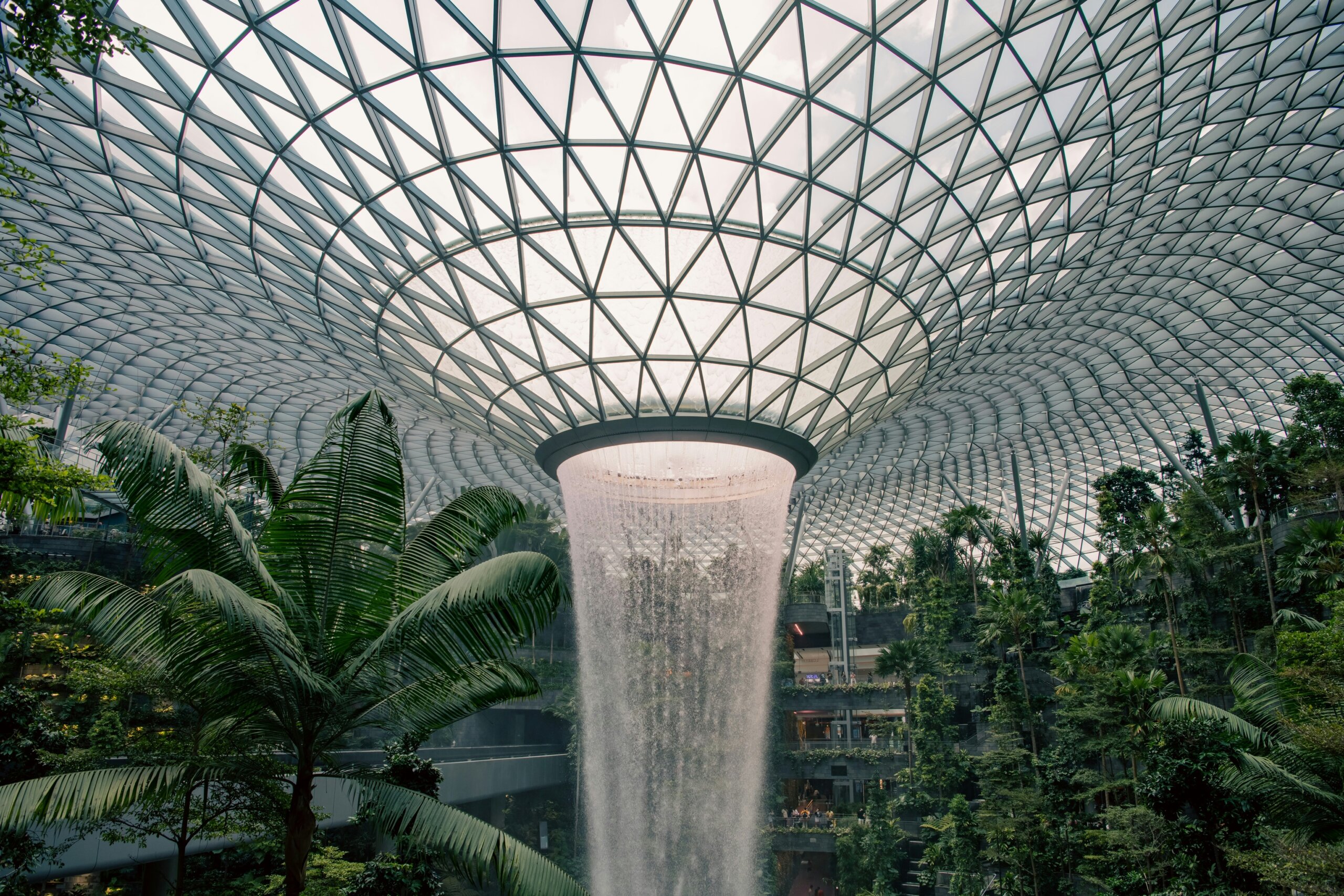 Singapore Changi Airport Rain Vortex with lush greenery and glass dome representing smooth airport security experience.