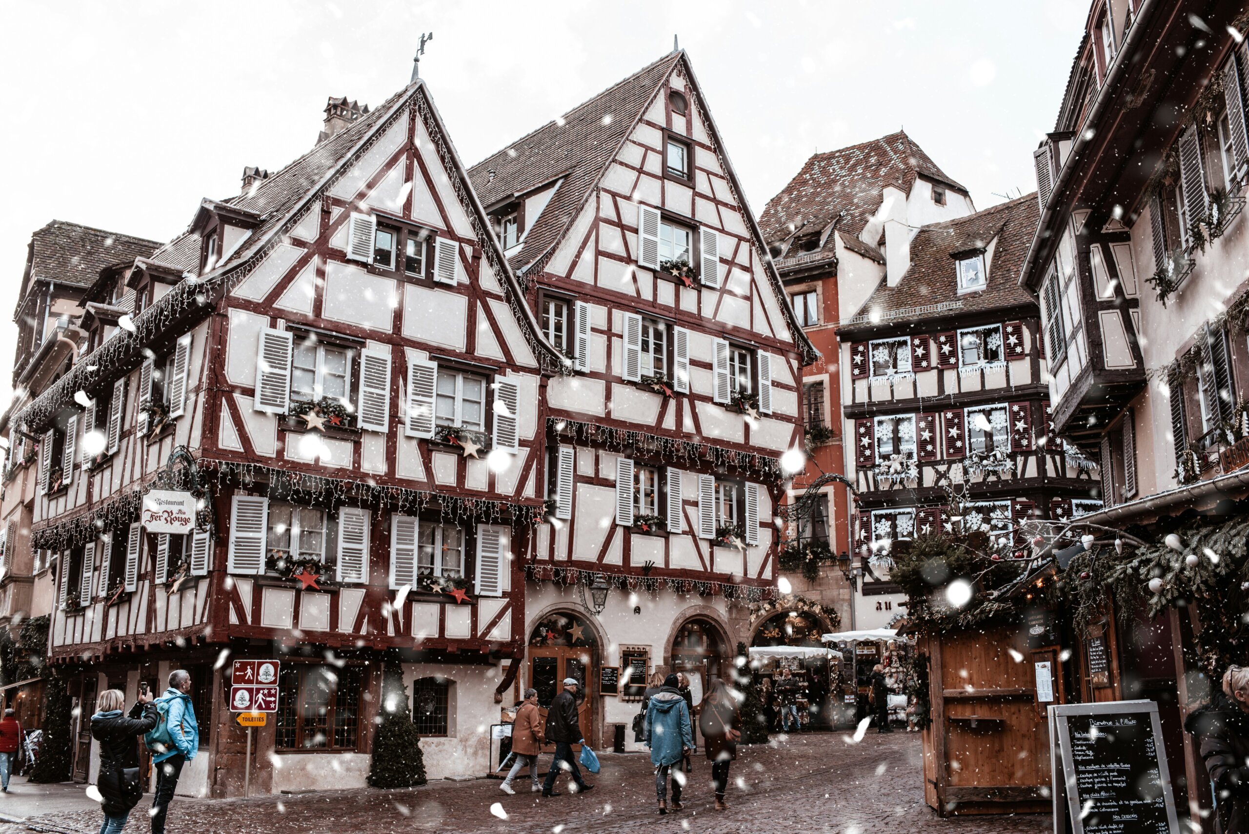 colmar, france: Cozy European village street covered in snow during winter