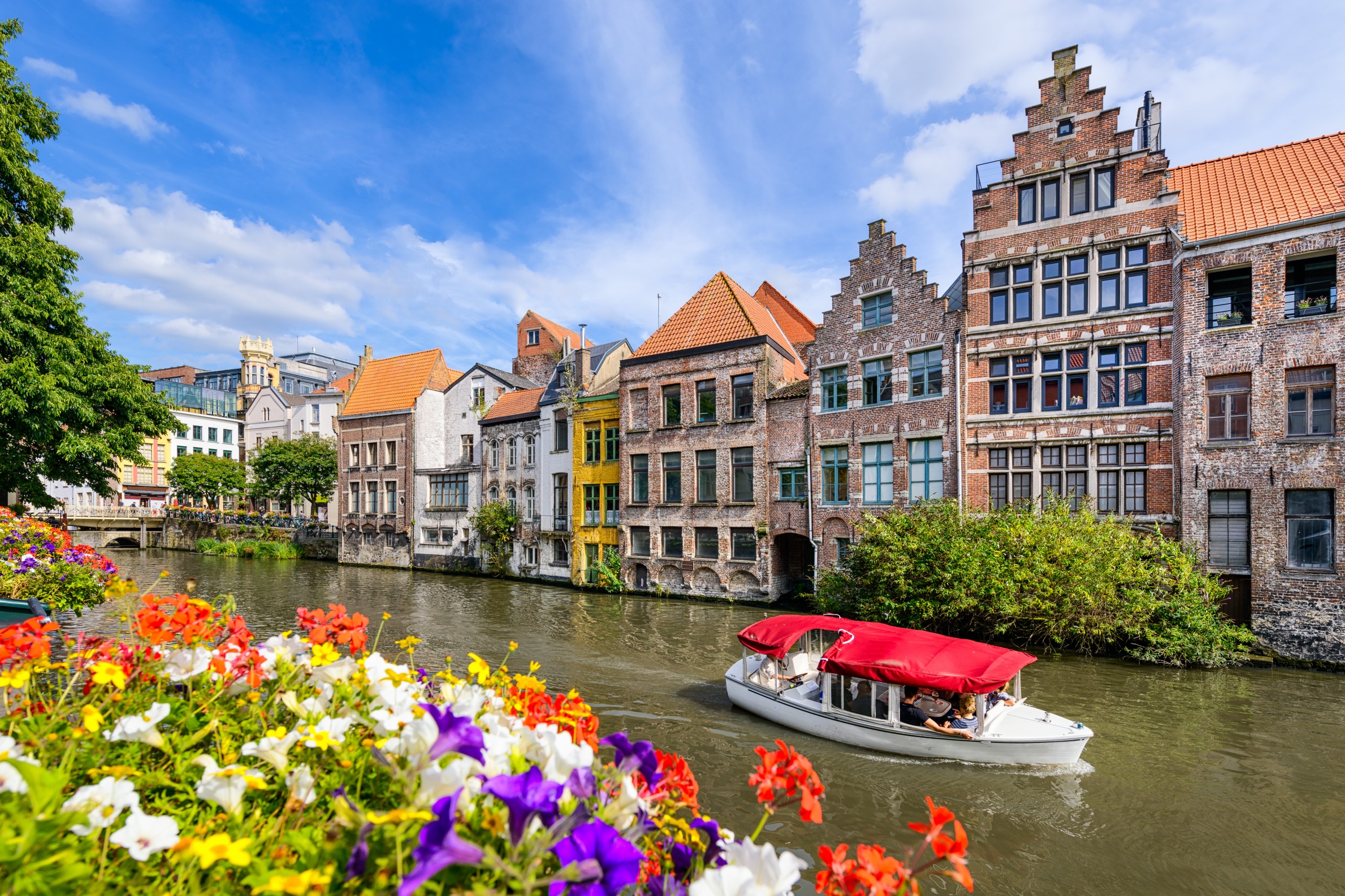 Boat on the river in Ghent, Belgium, with historic buildings and scenic waterfronts