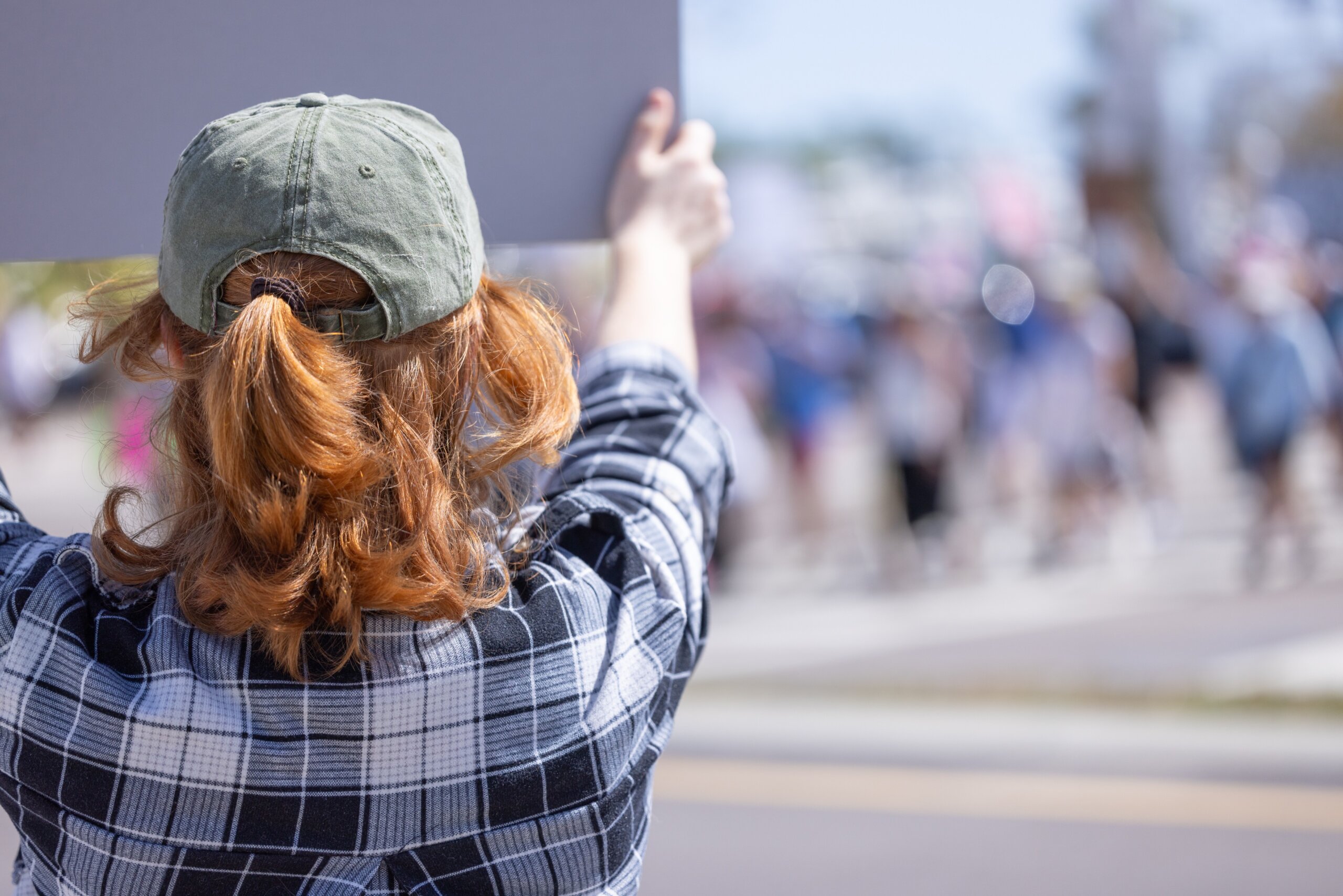 An anonymous woman holds up a sign at a the April 5, 2025, Hands Off protest against the Trump administration with the goal of protecting U.S. democracy.