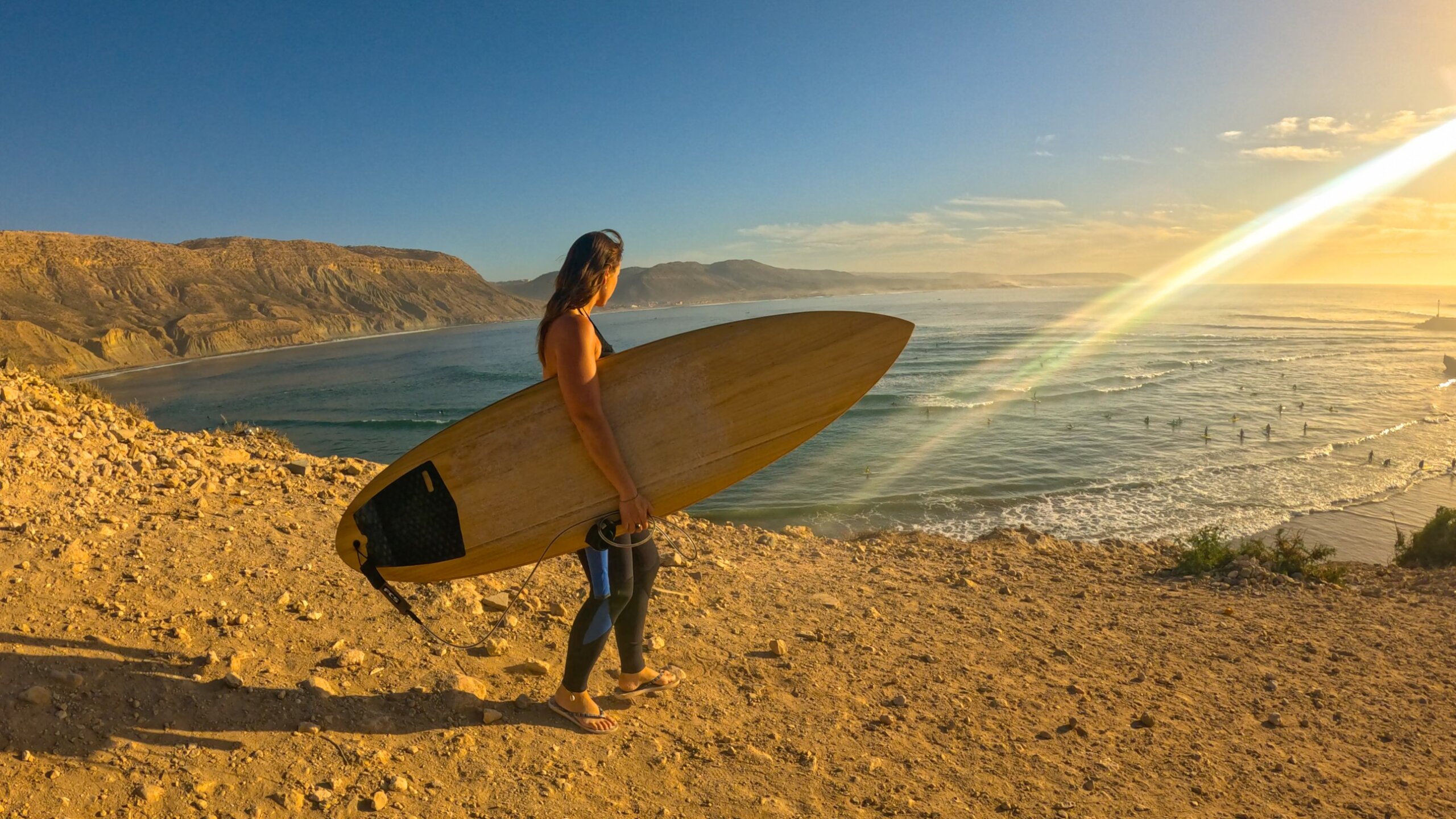 surfer overlooking the ocean in Imsouane surf town, Morocco