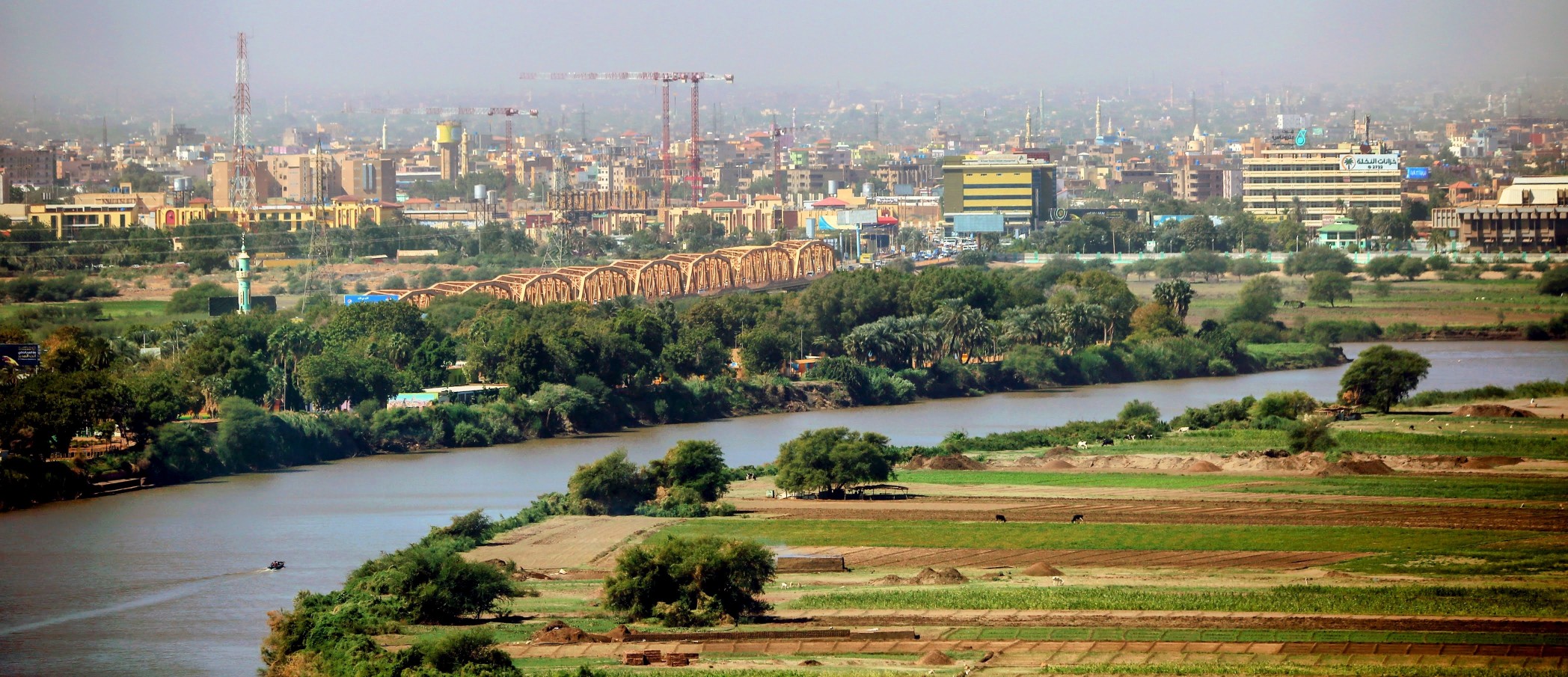 Blue Nile at Khartoum – Urban Skyline, Riverfront Green Belt, and Historic Steel Bridge