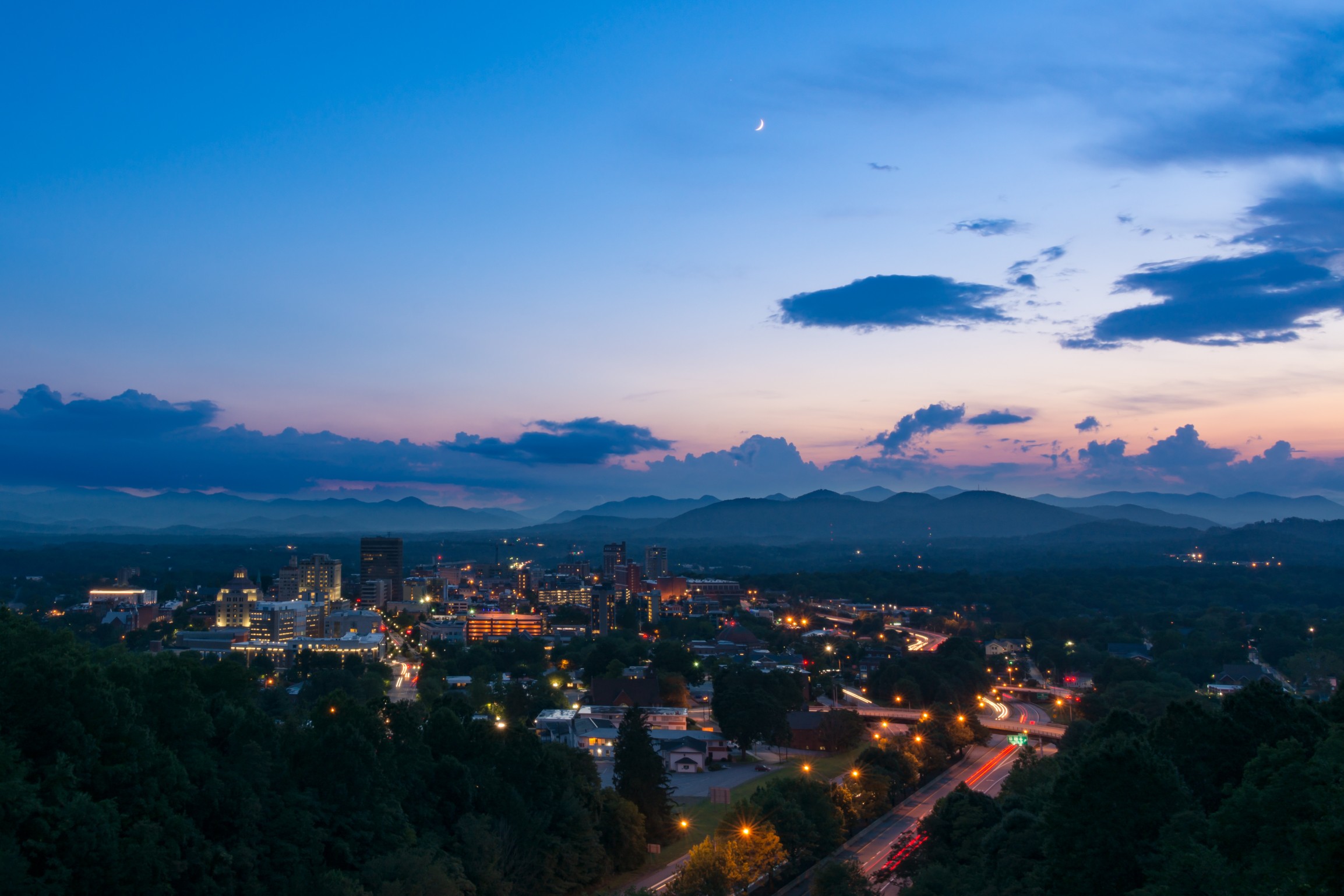 Twilight scene overlooking Asheville, a destination vacation mountain town in western North Carolina
