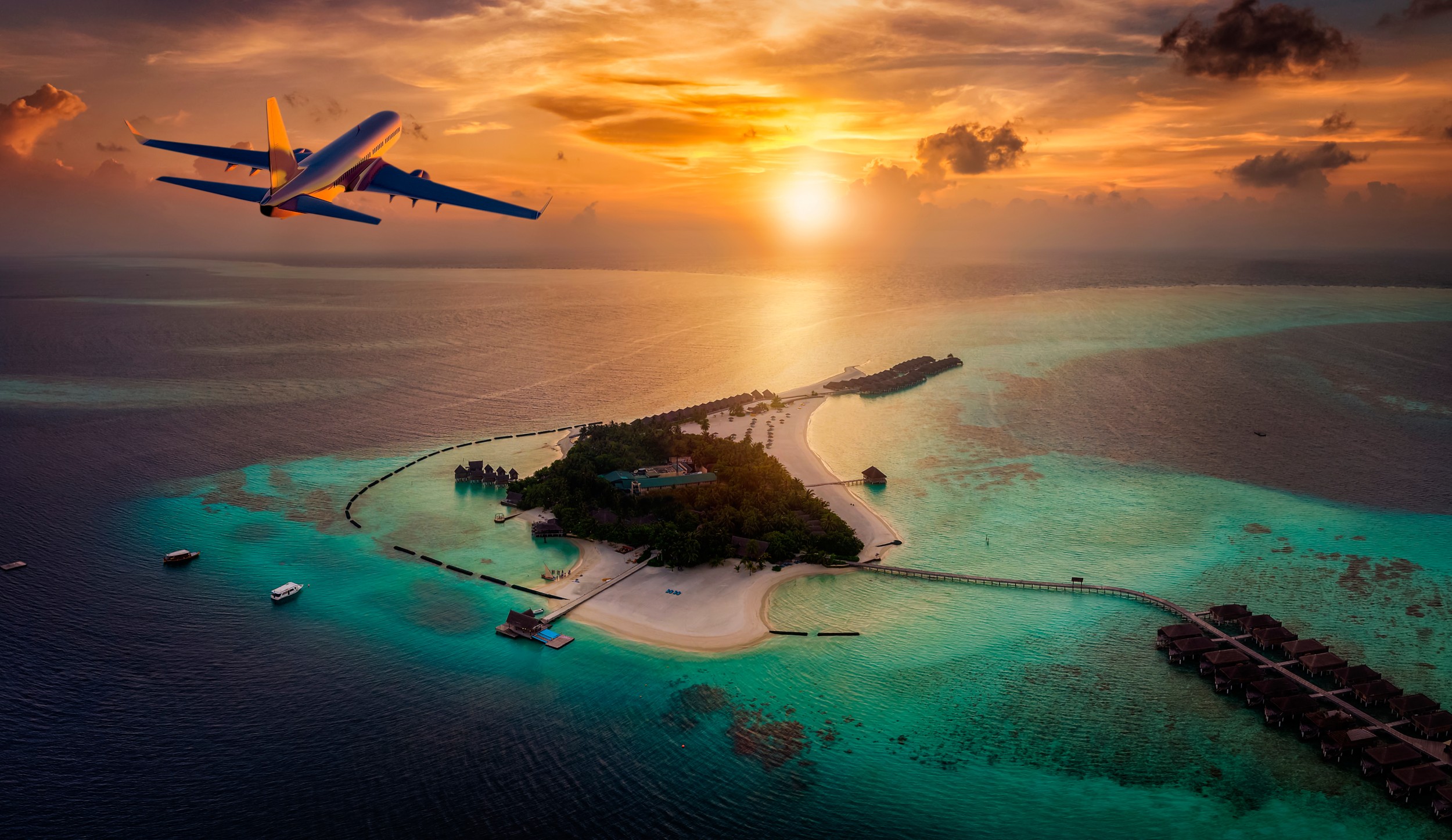 Travel concept with an airplane flying towards a tropical paradise island in the Maldives during sunset time
