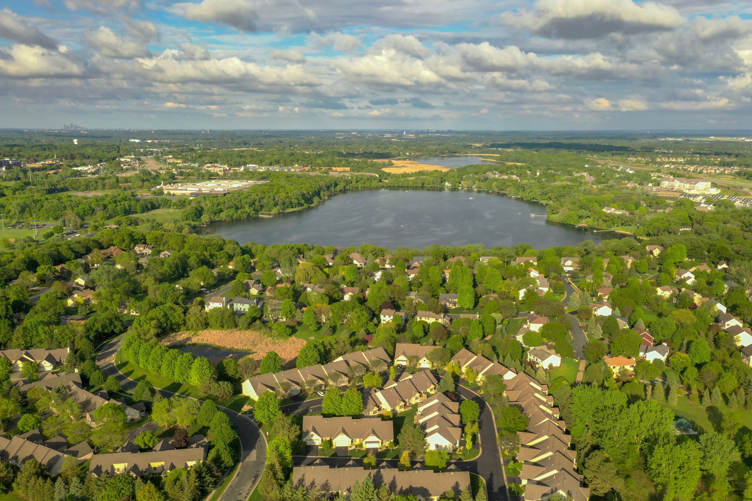 Suburbs Surround Lake Down Minneapolis in Far Distance
