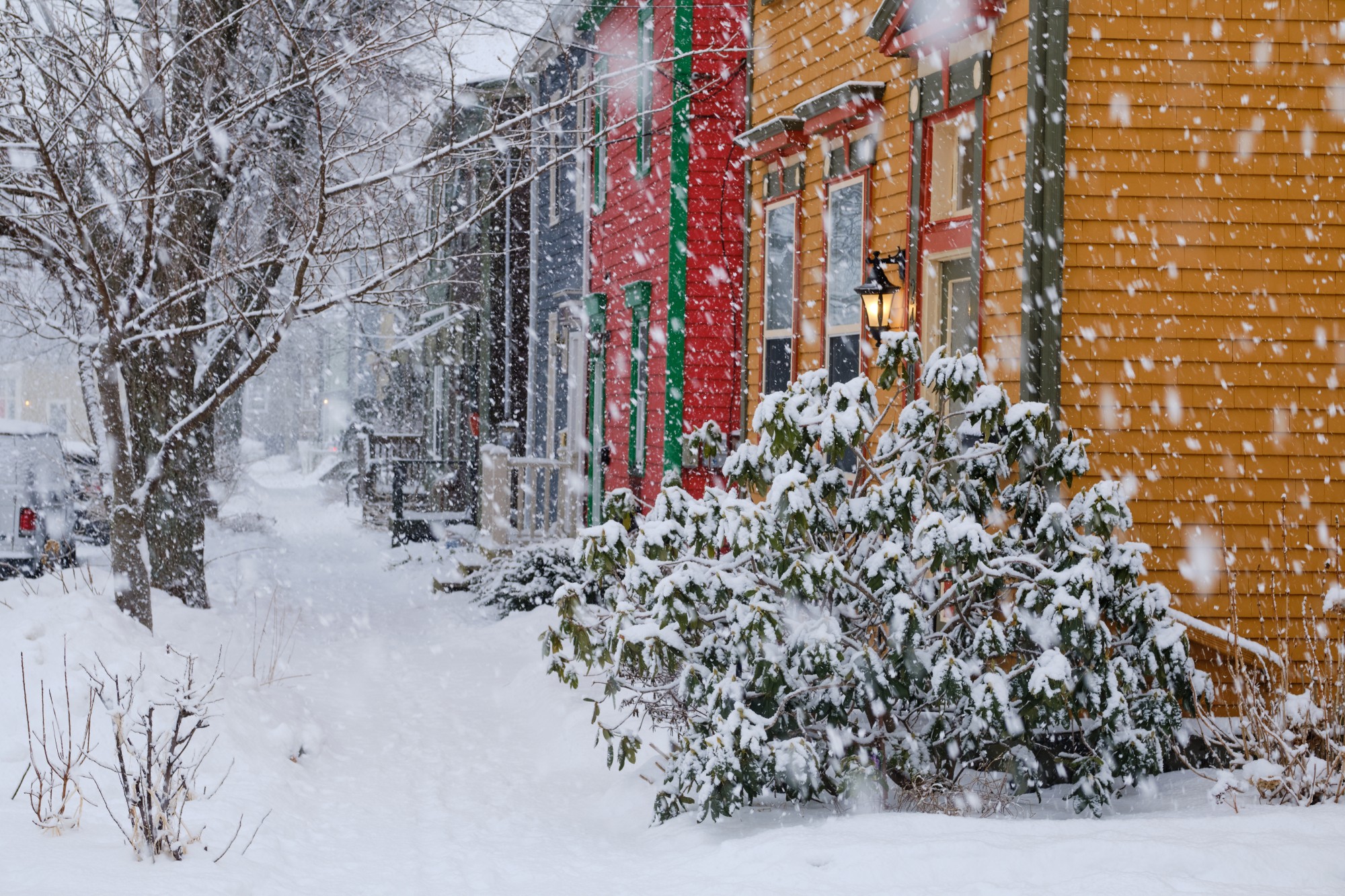 snow winter storm on the street of Halifax making for a difficult morning commute. Steady snow falling on the colourful traditional houses of Halifax North area .