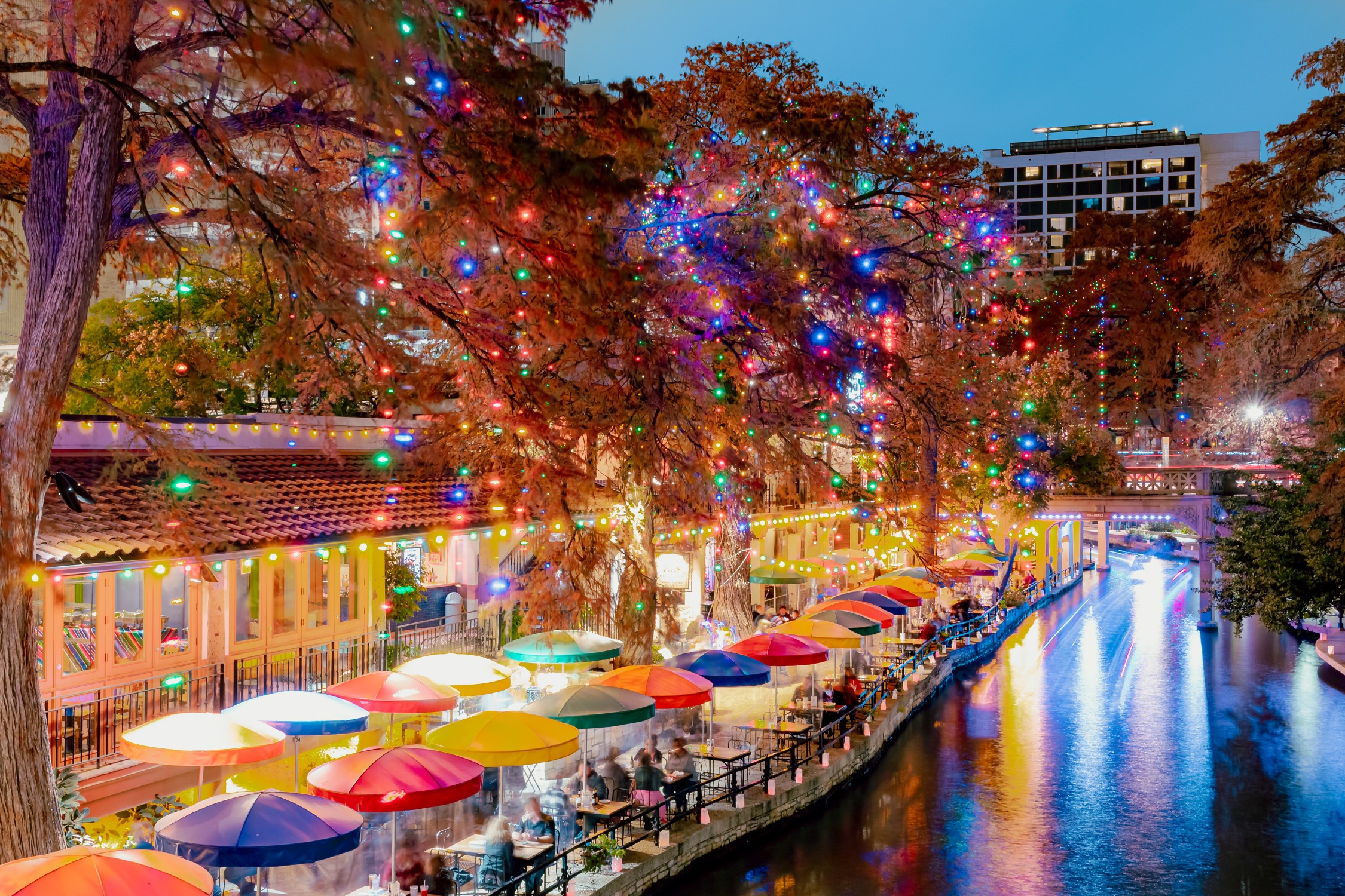 Colorful LED Christmas lights at the restaurants at the San Antonio Riverwalk on a December Texas evening
