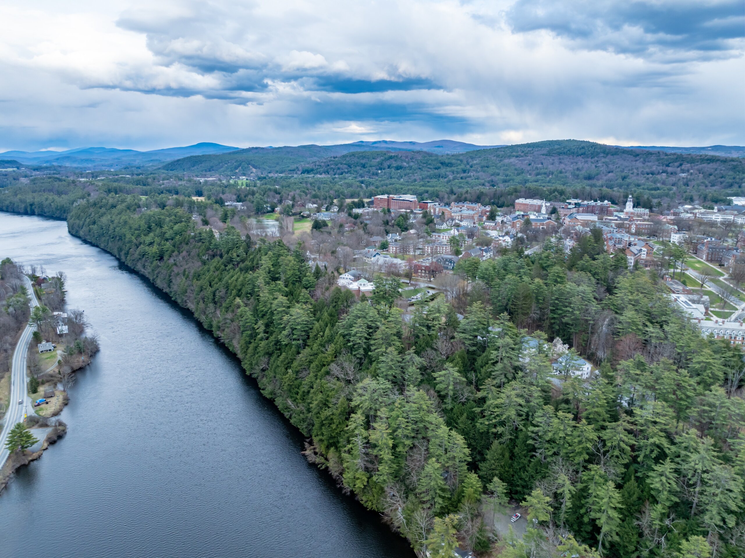 Spring aerial photo of Hanover, NH and Connecticut River on a partly cloudy day.

