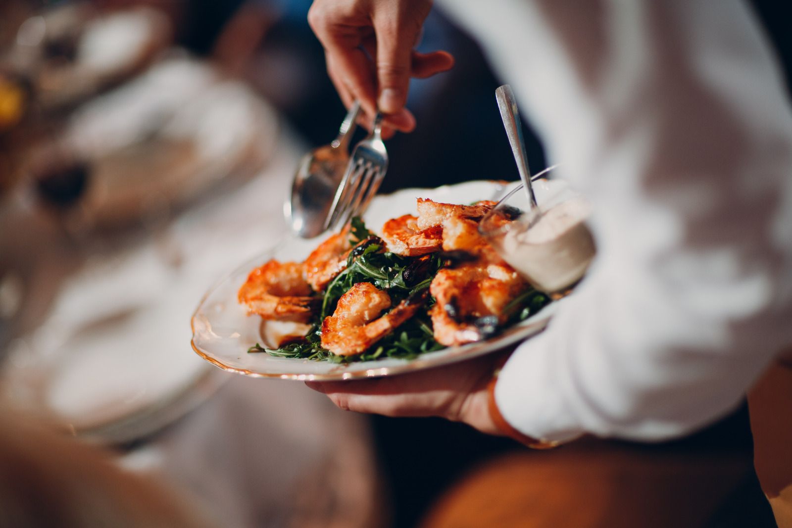 Server holding a plate of food for a list of rude restaurants