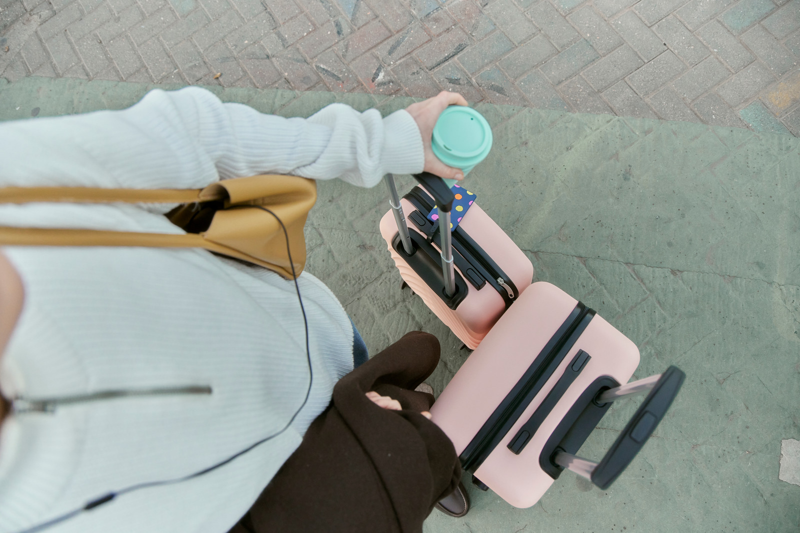 Traveler with rolling suitcase and coffee, representing a PTO strategy to maximize vacation days in 2026