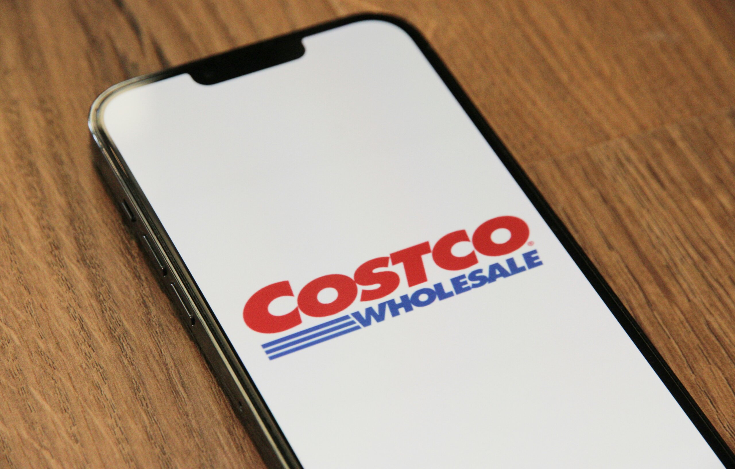 Costco logo on a smartphone screen, representing Costco vacations and Costco Travel packages