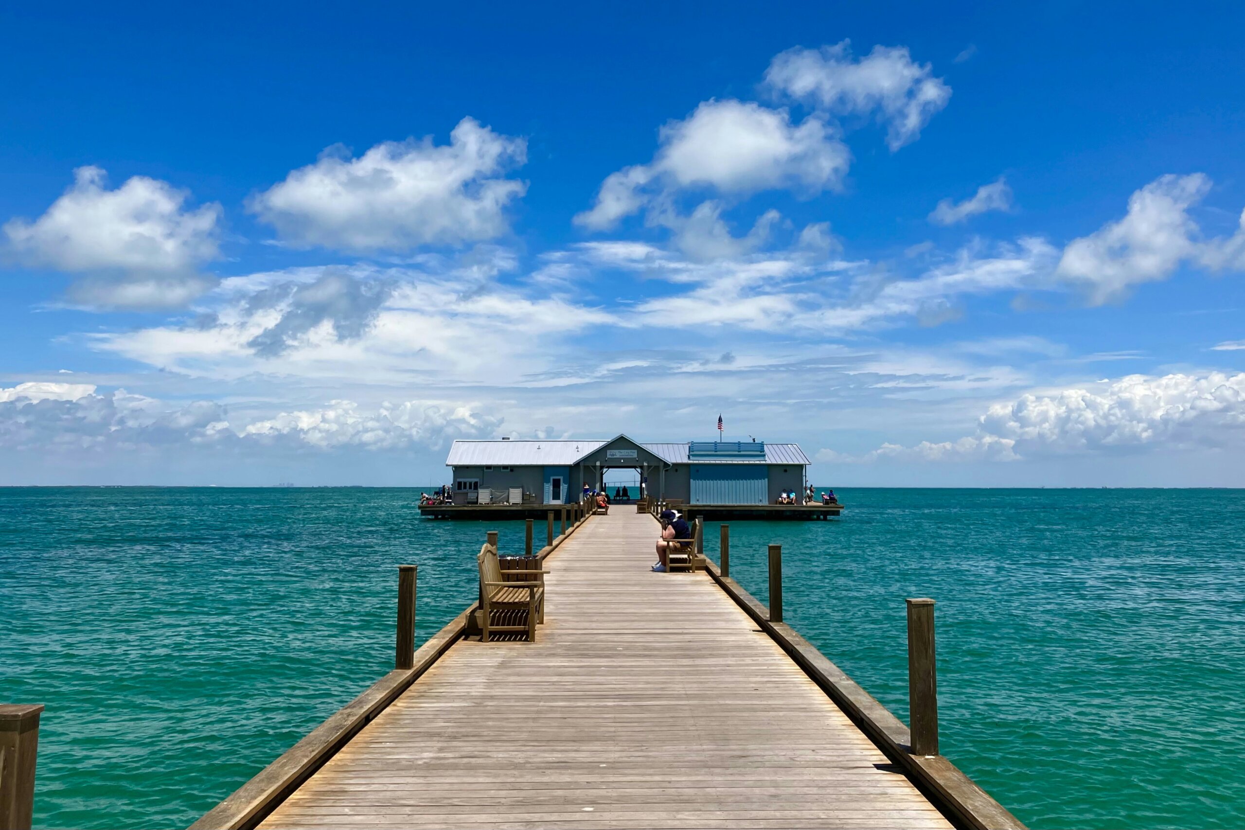 Wooden pier over turquoise water on Anna Maria Island, a secret Florida island
