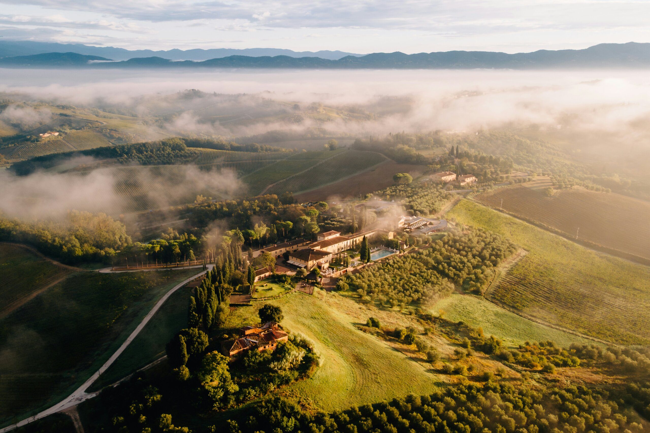 Aerial view of a farm and fields in morning fog